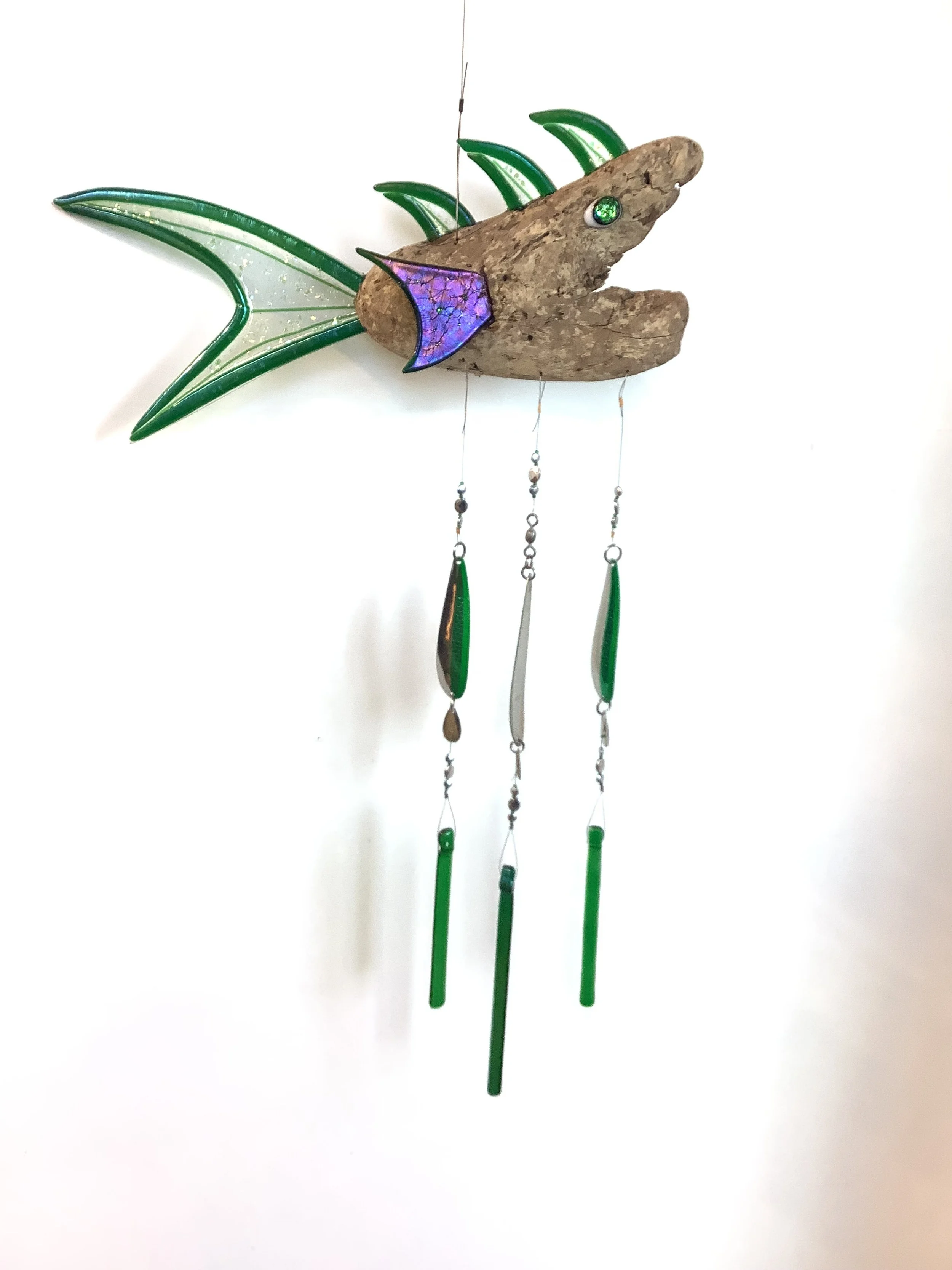 $140  " Green with envy" Green fused glass driftwood fish chime with silver and green beads. Hangs 34"x15" with green fishing lures and green fused glass chimes. Contact to purchase.