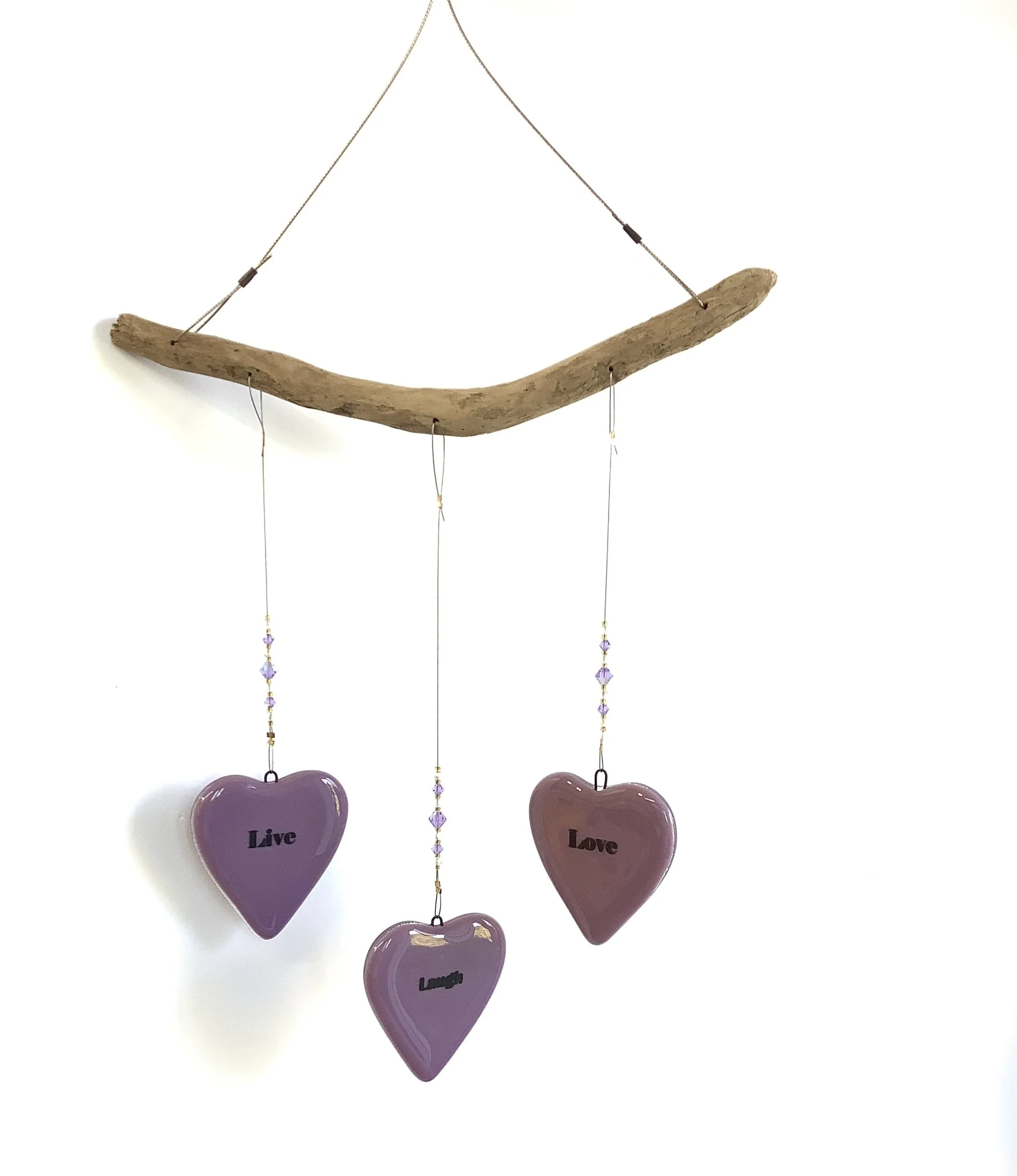 $80
Live, Laugh, Love grape glass hearts with purple and gold beads. Hangs 17"x8.5" from stainless wire and Vancouver Island driftwood. Contact to purchase.