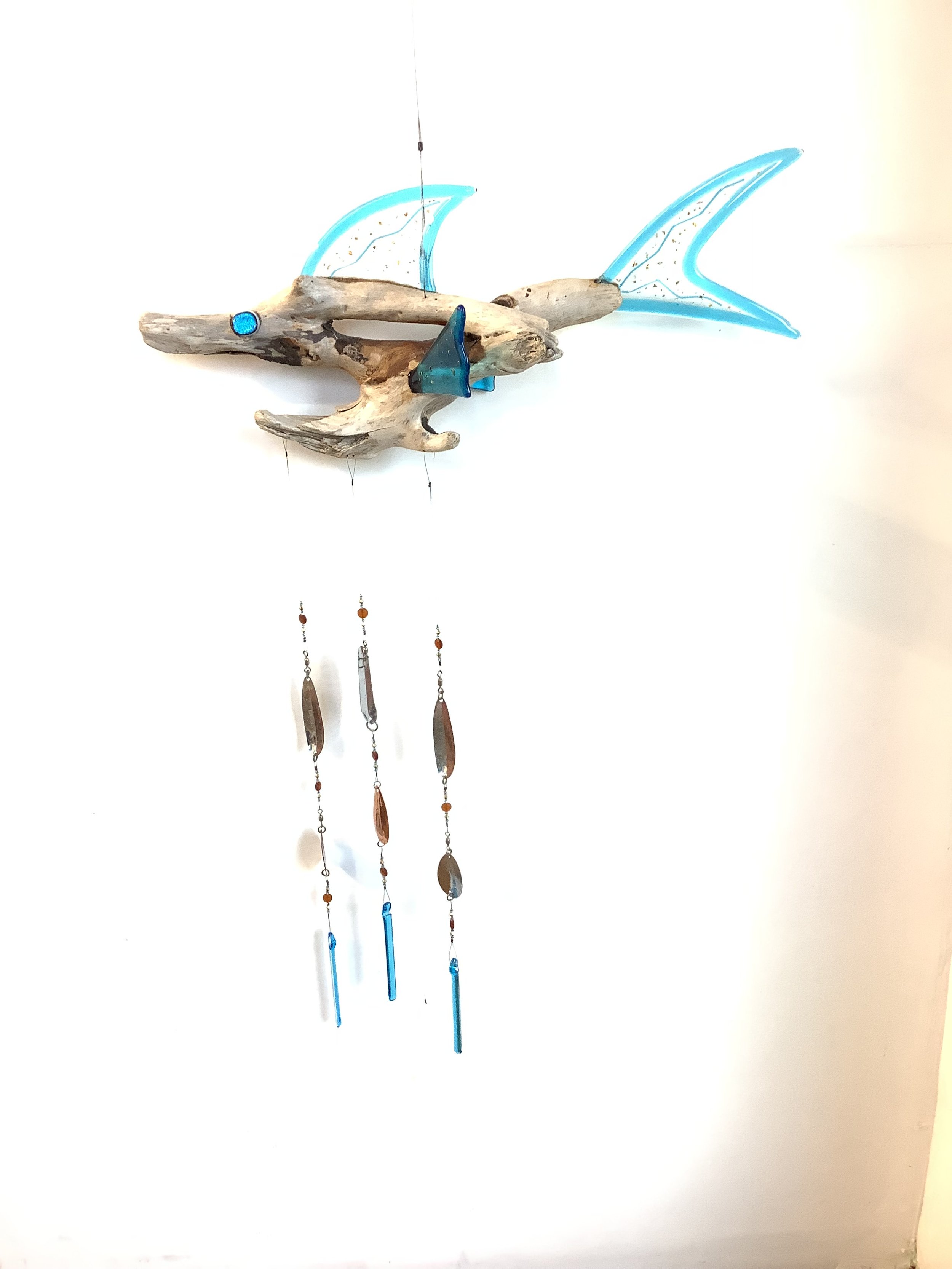$160 "Fishful Thinking" Blue fused glass driftwood fish chime with blue , brown, and gold beads. Hangs from stainless wire with fishing lures and fused glass chimes. Contact to purchase.