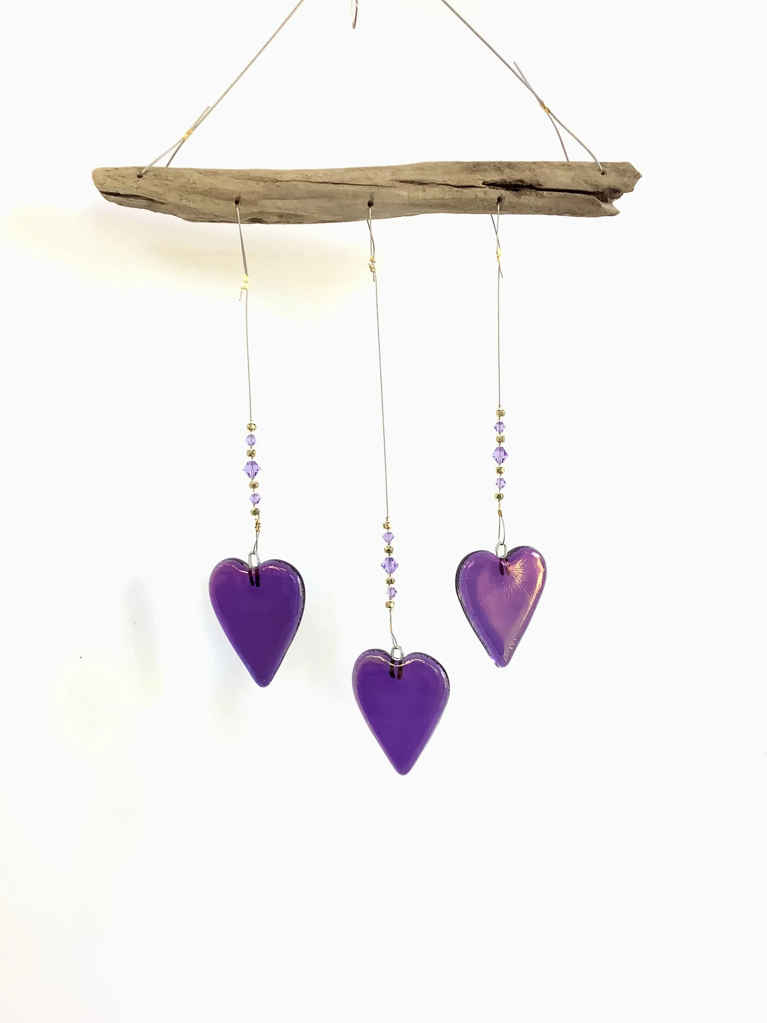 $45
Purple iridescent fused glass hearts with purple and gold beads. Hangs 13"x7" from stainless wire and Vancouver Island driftwood. Contact to purchase.