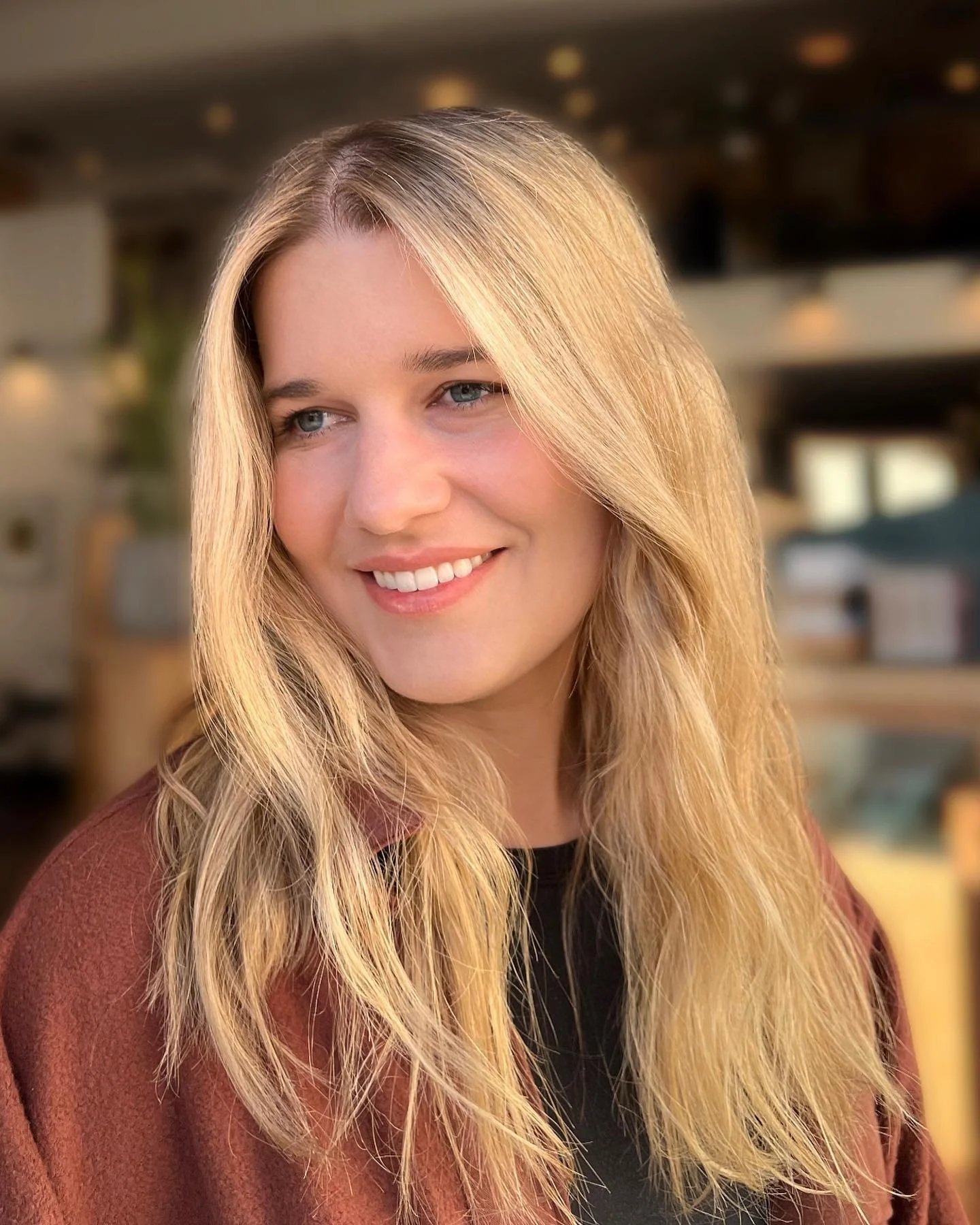 Long hair blended balayage styled at The Co-Artist Studio in Capitola, California, featuring soft blonde dimension and a seamless finish.