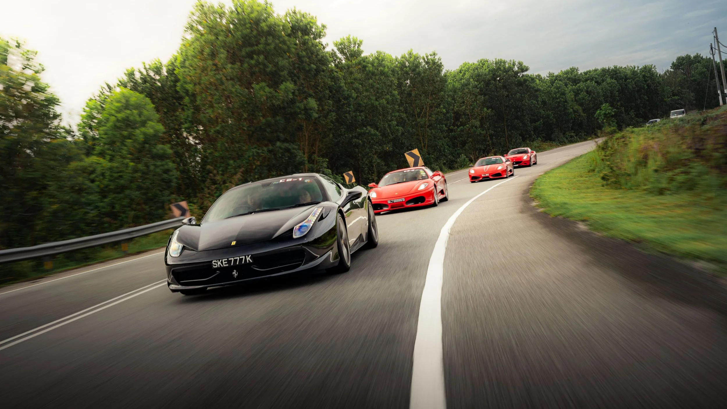 Automotive lifestyle photography by Han Yang Tay Photography, capturing Ferrari Owners Club Singapore on an overseas drive with a Ferrari convoy on the road.