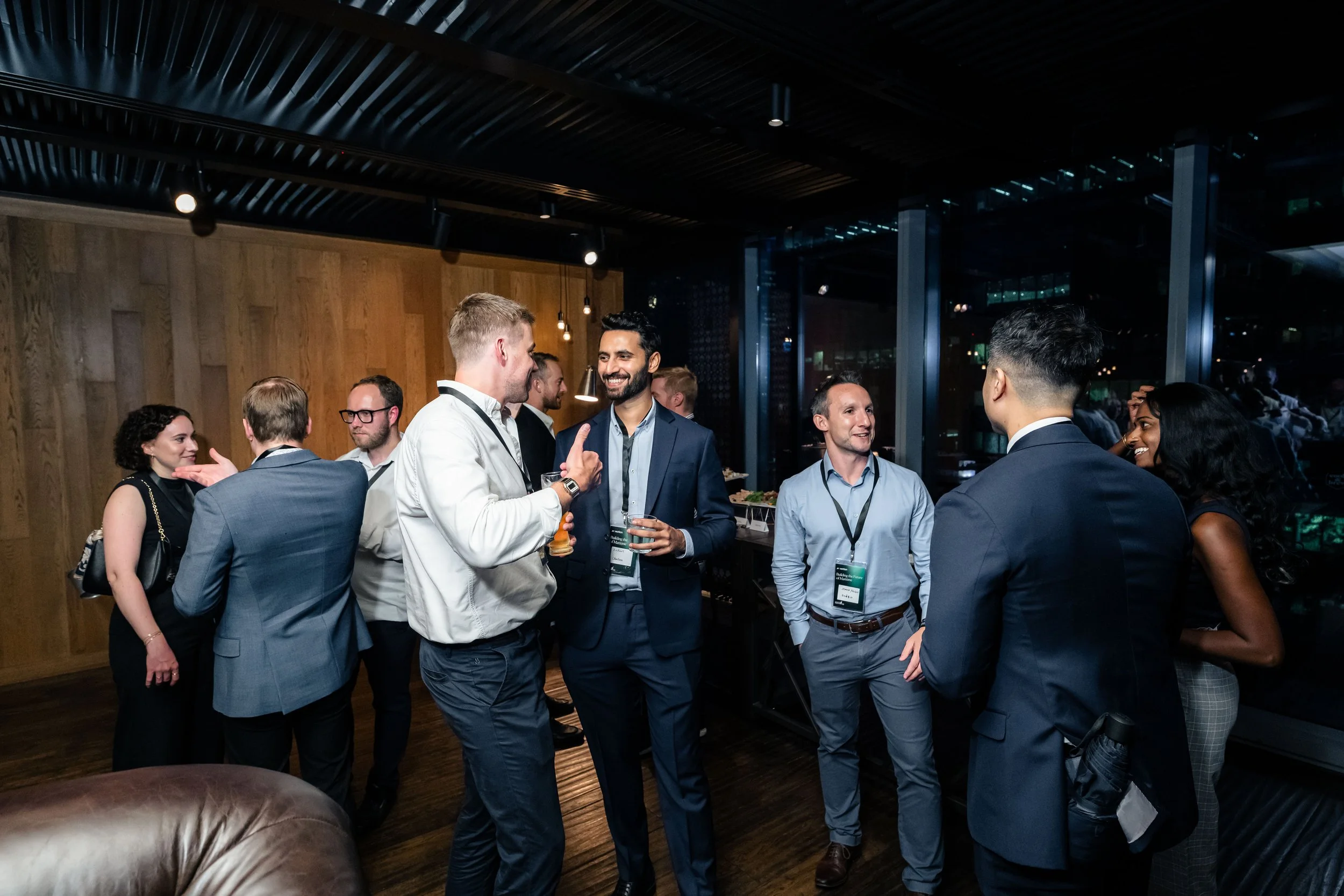 Corporate networking event photography in Singapore by Han Yang Tay Photography, capturing guests in conversation at the Motion Ventures Singapore Maritime Week event.