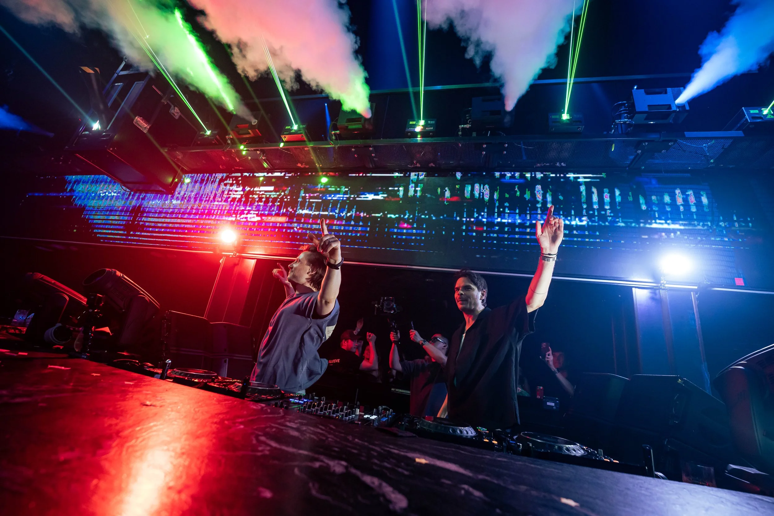 DJ Lucas & Steve interact with the crowd during a live performance at Marquee Singapore, with CO2 effects, colourful stage lighting and an energetic electronic dance music atmosphere.