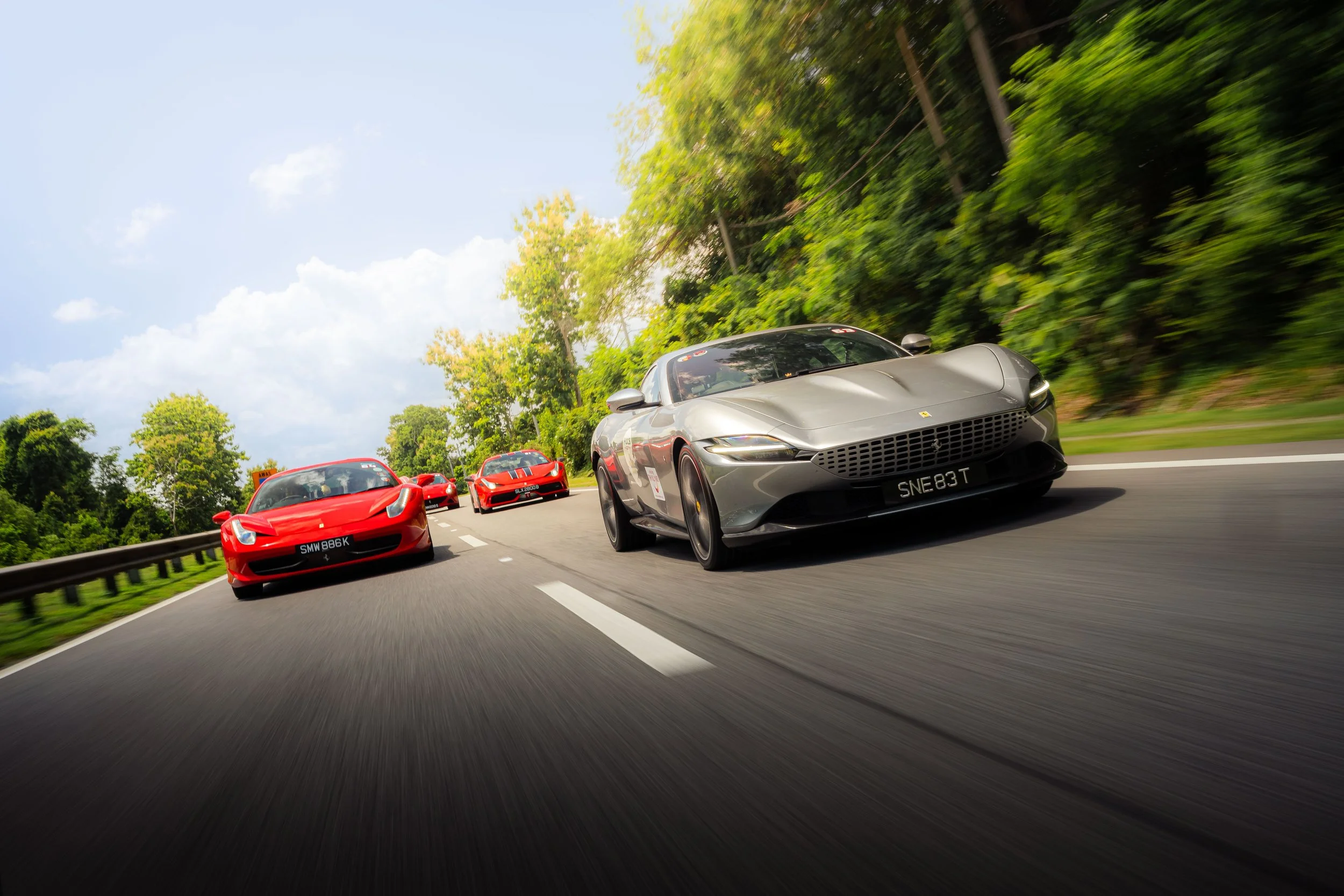 Grey Ferrari Roma leading a convoy of Ferraris through the scenic roads of Krabi, Thailand during the Ferrari Owners' Club Singapore Overseas Drive.