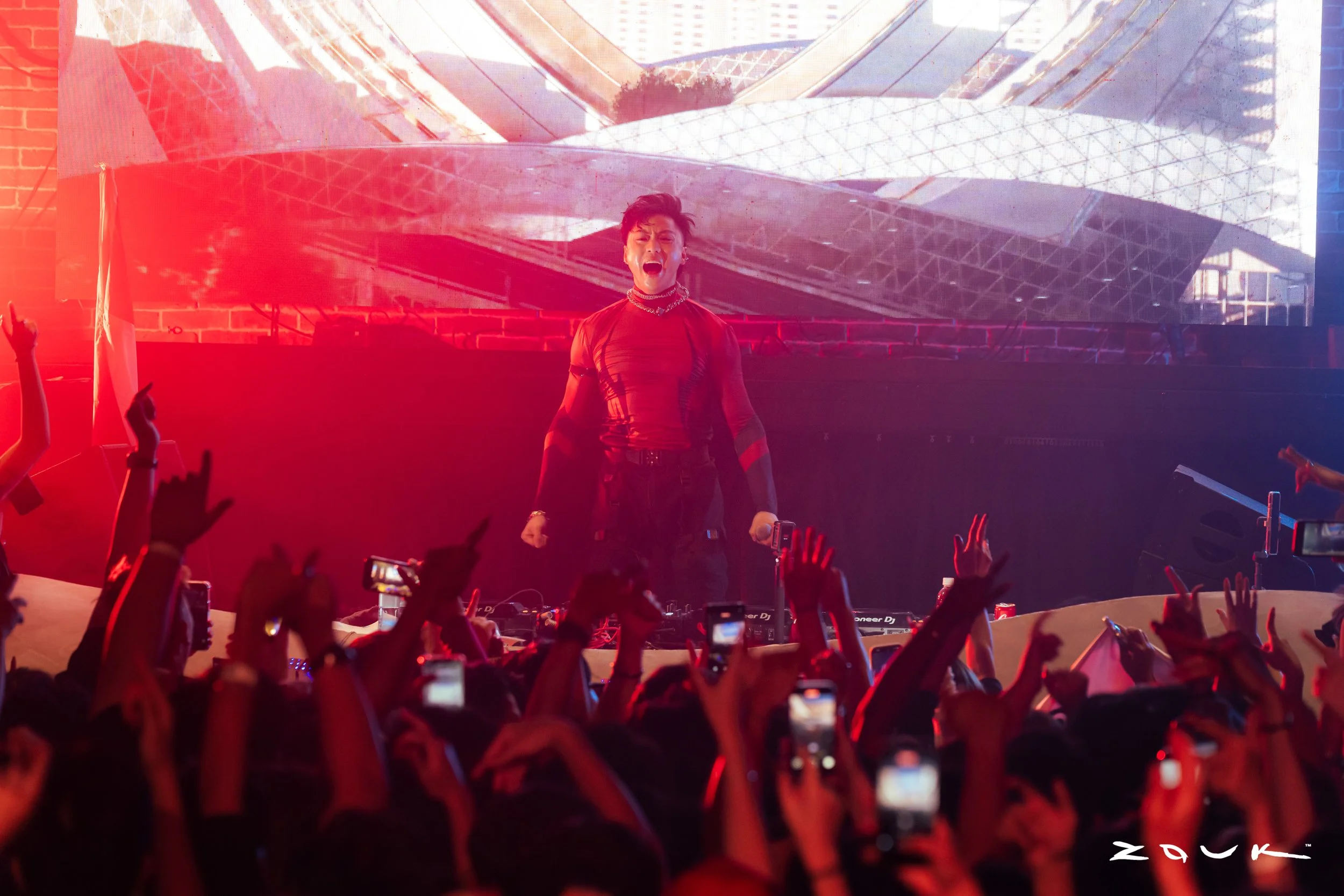 DJ Wukong performing live at Zouk Singapore as CO2 cannons erupt above a packed crowd, creating an electrifying nightclub atmosphere with immersive stage production and energetic audience interaction.
