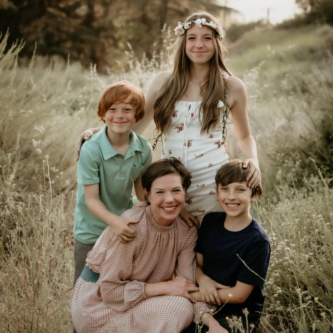 kathleen cross of gusd with her children in a field