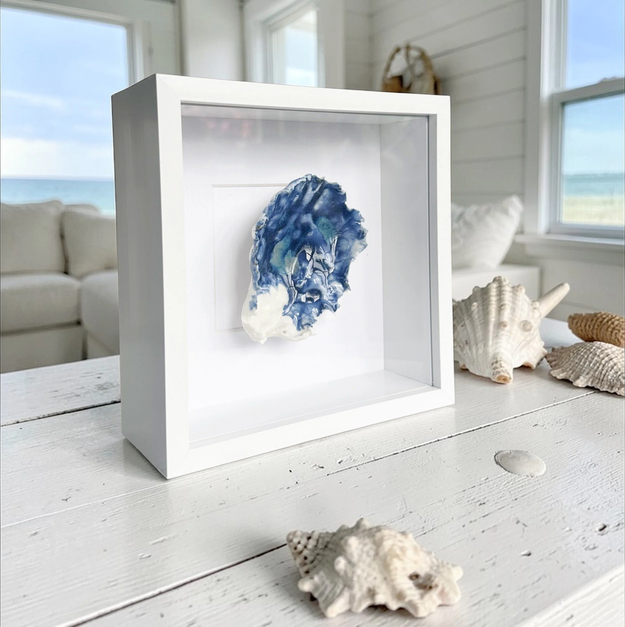 Elegant textured coastal wall art featuring sculpted porcelain shells