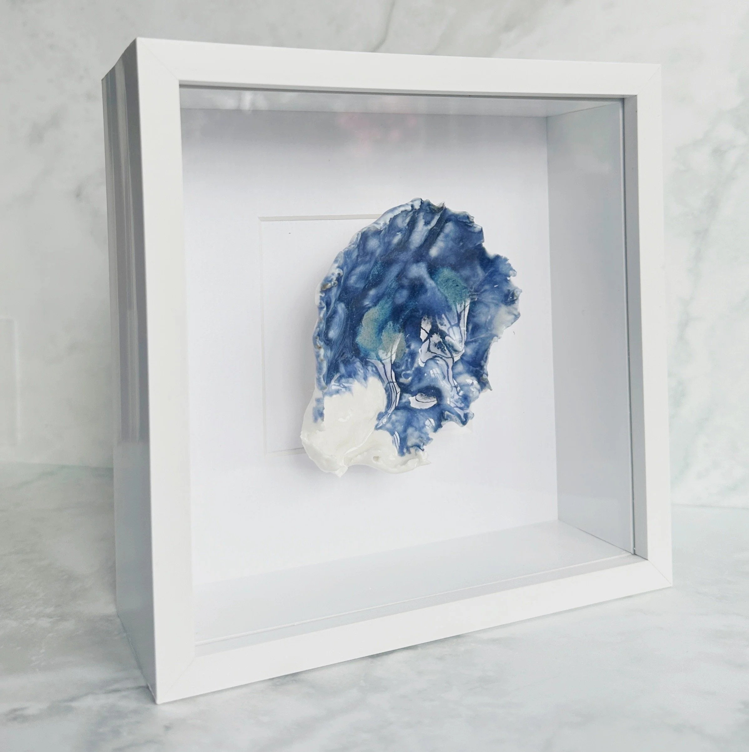 Elegant textured coastal wall art featuring sculpted porcelain shells