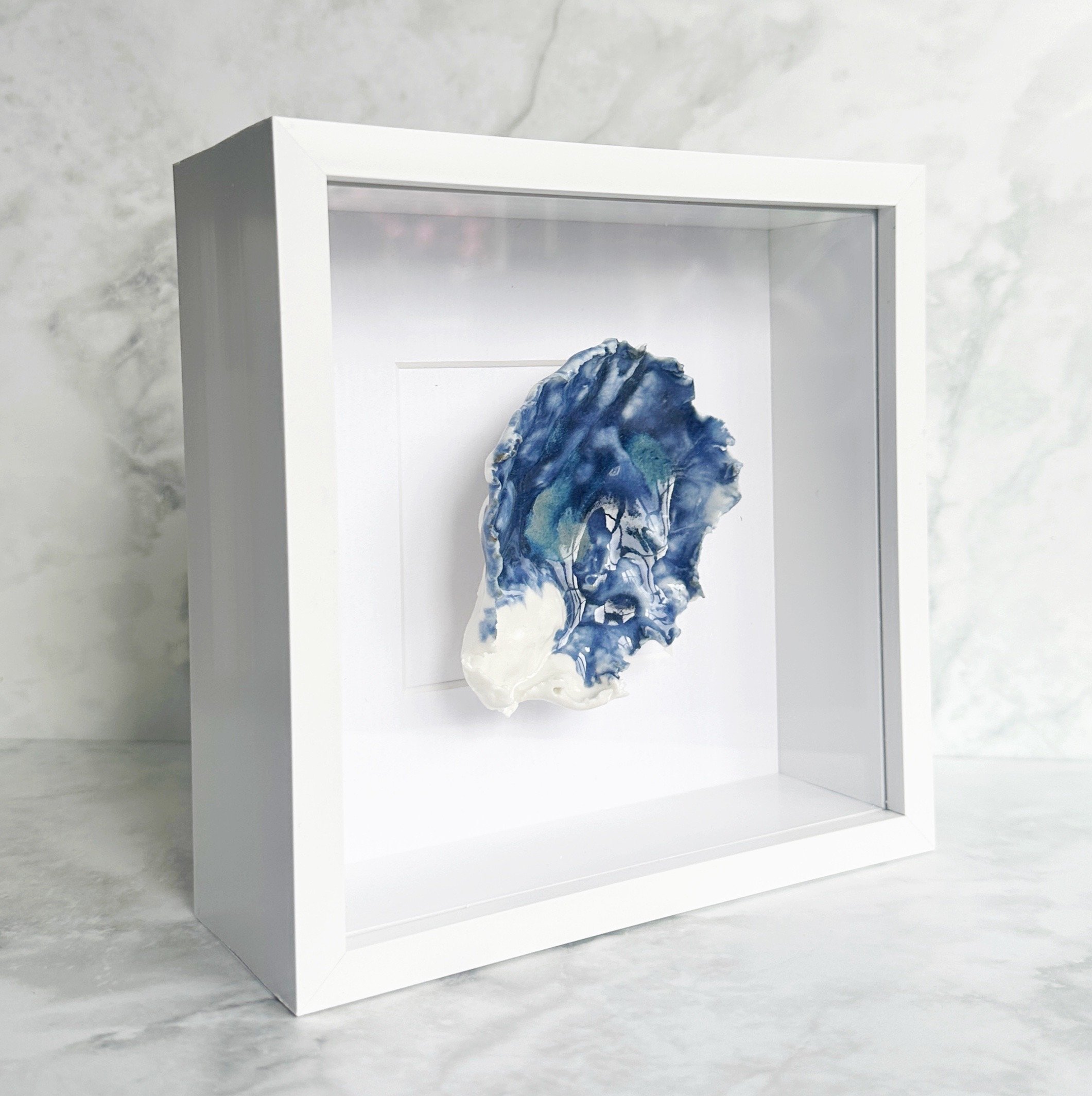 Elegant textured coastal wall art featuring sculpted porcelain shells