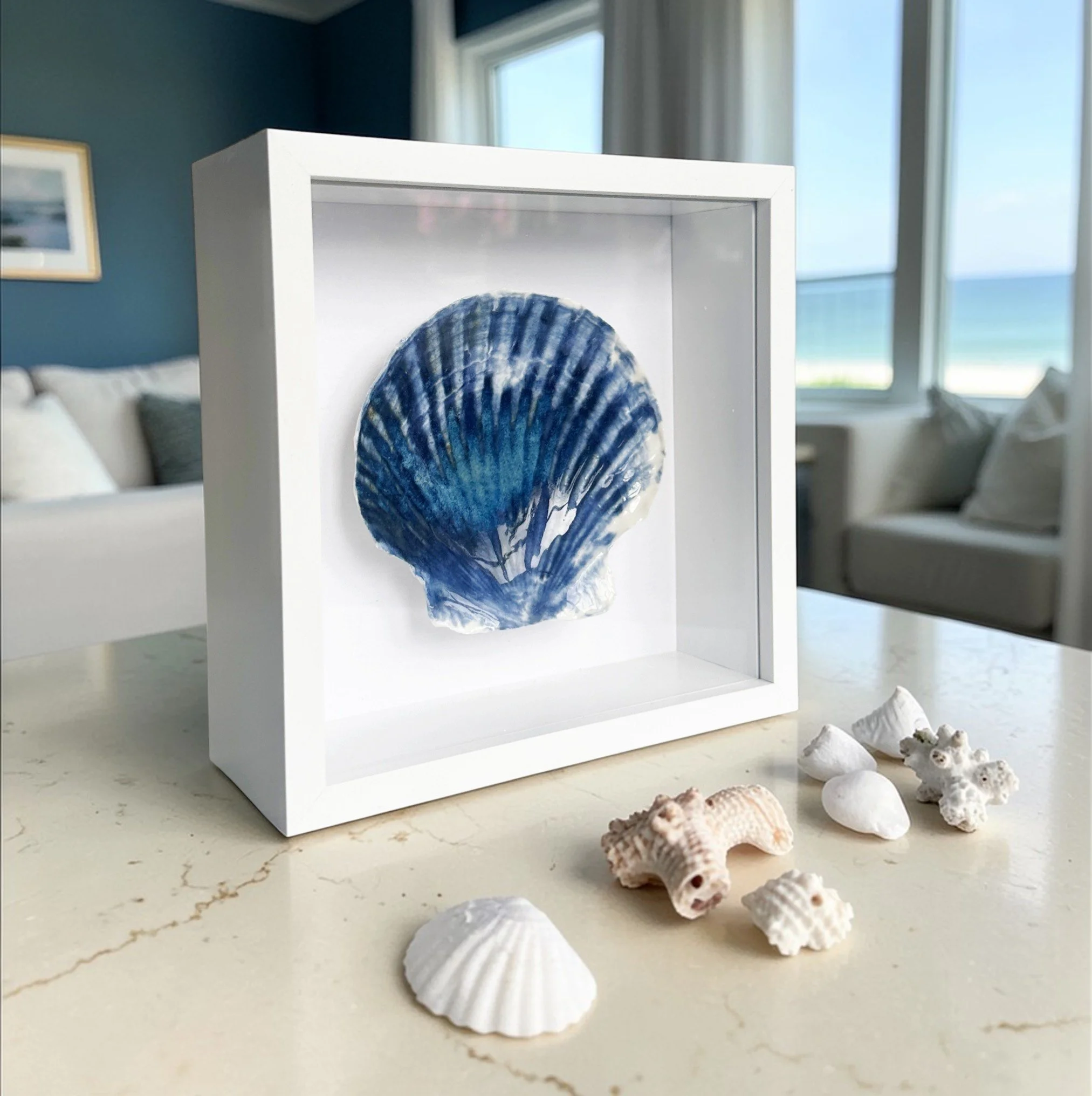 This textured coastal wall art features handcrafted porcelain shell art, creating a unique piece of beach art inspired by the Sussex coastline