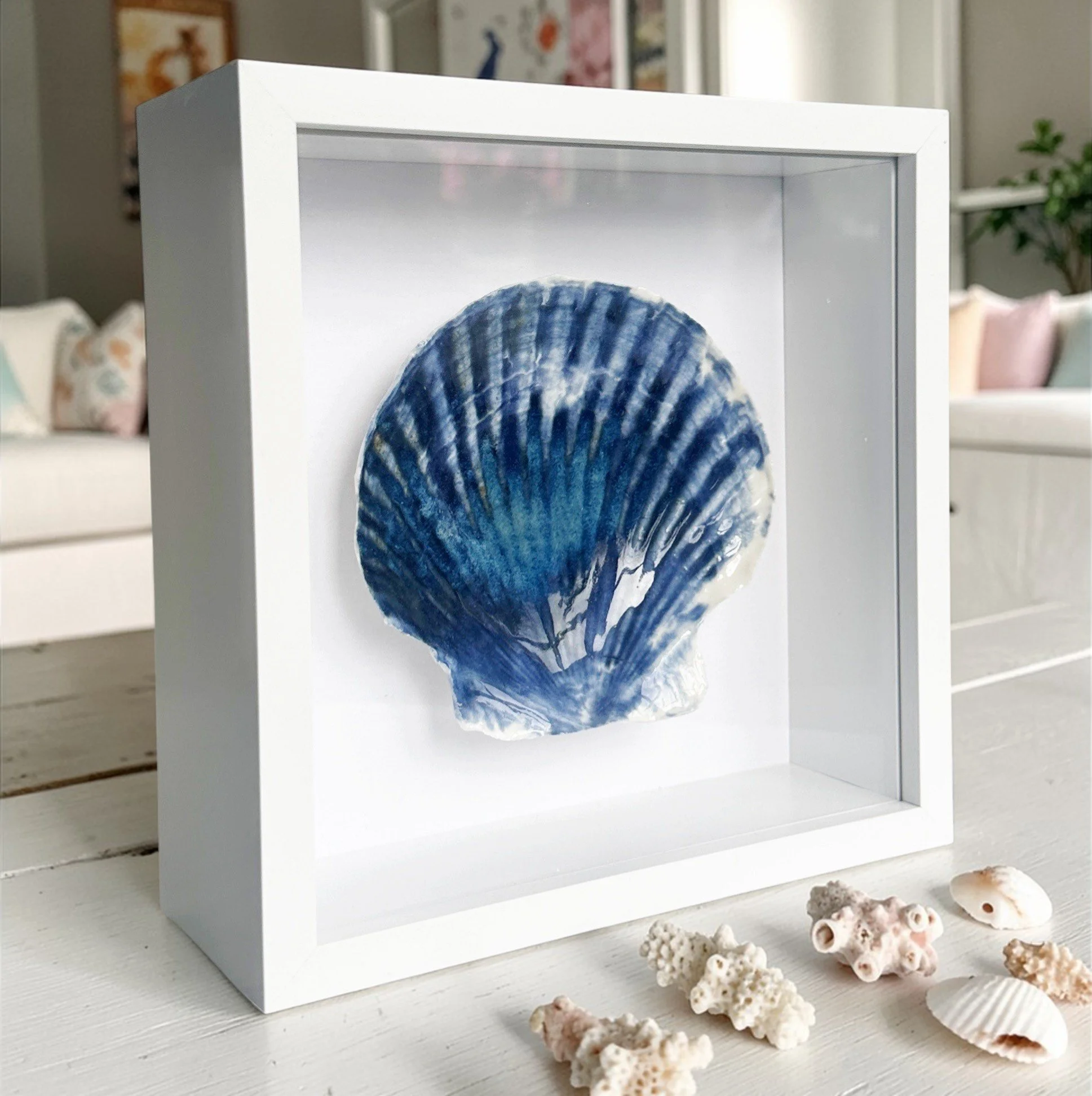 This textured coastal wall art features handcrafted porcelain shell art, creating a unique piece of beach art inspired by the Sussex coastline