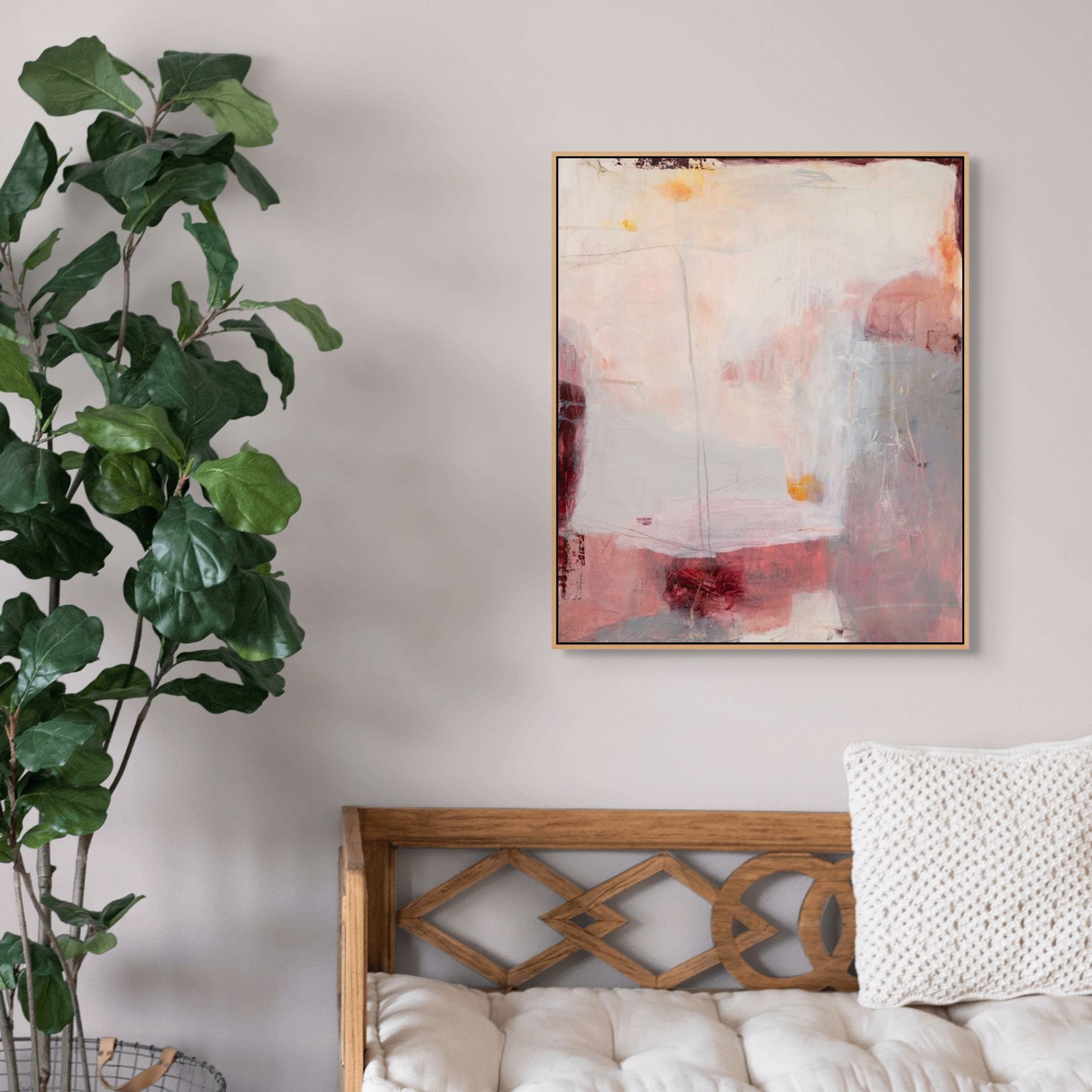 Pink, gray, and cream framed, abstract art print on canvas by Laurie Baars, shown in a living room.