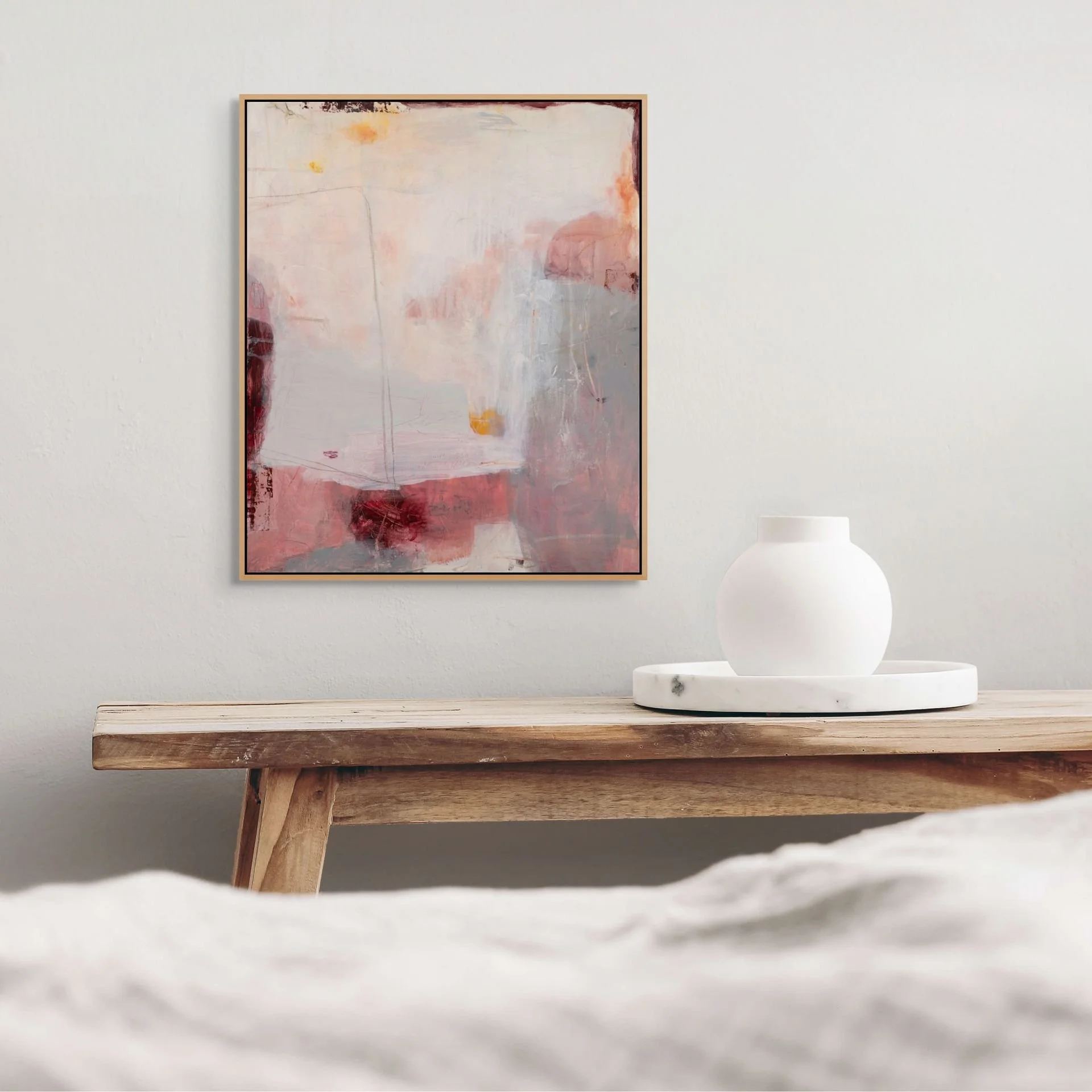 Pink, gray, and cream contemporary abstract art print by Laurie Baars adds a colorful, calming touch to a minimalist bedroom.