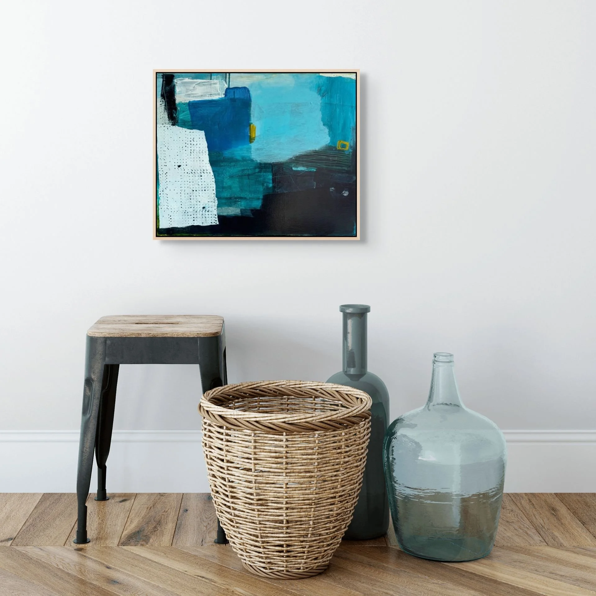Blue and white framed abstract art print hung on the wall of a home with modern decor.