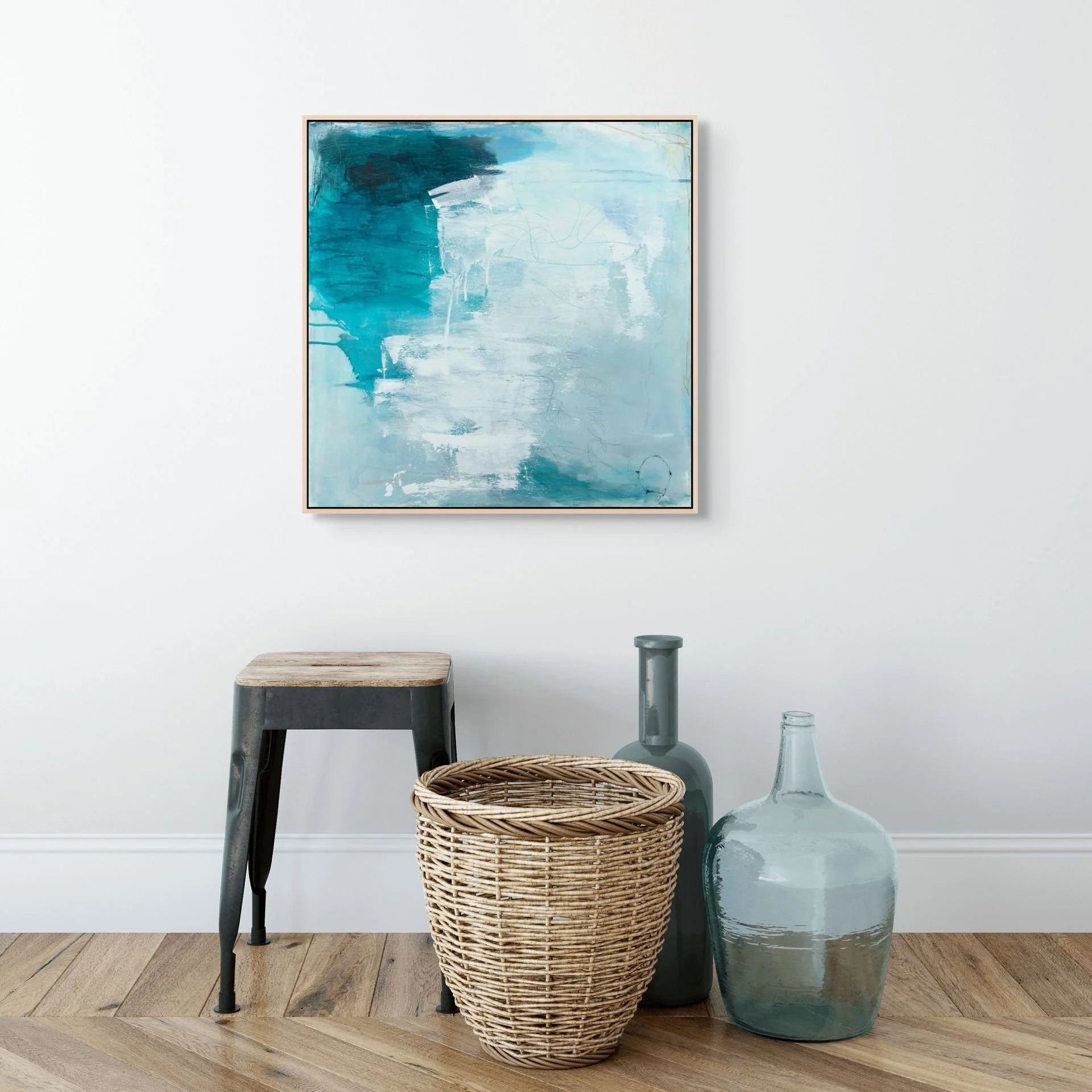 Blue and white framed abstract art print hung on the wall of an entryway.