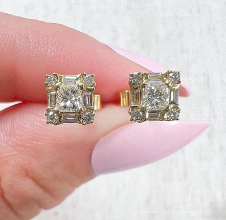Pair of gold earrings with square-shaped design featuring natural diamonds.