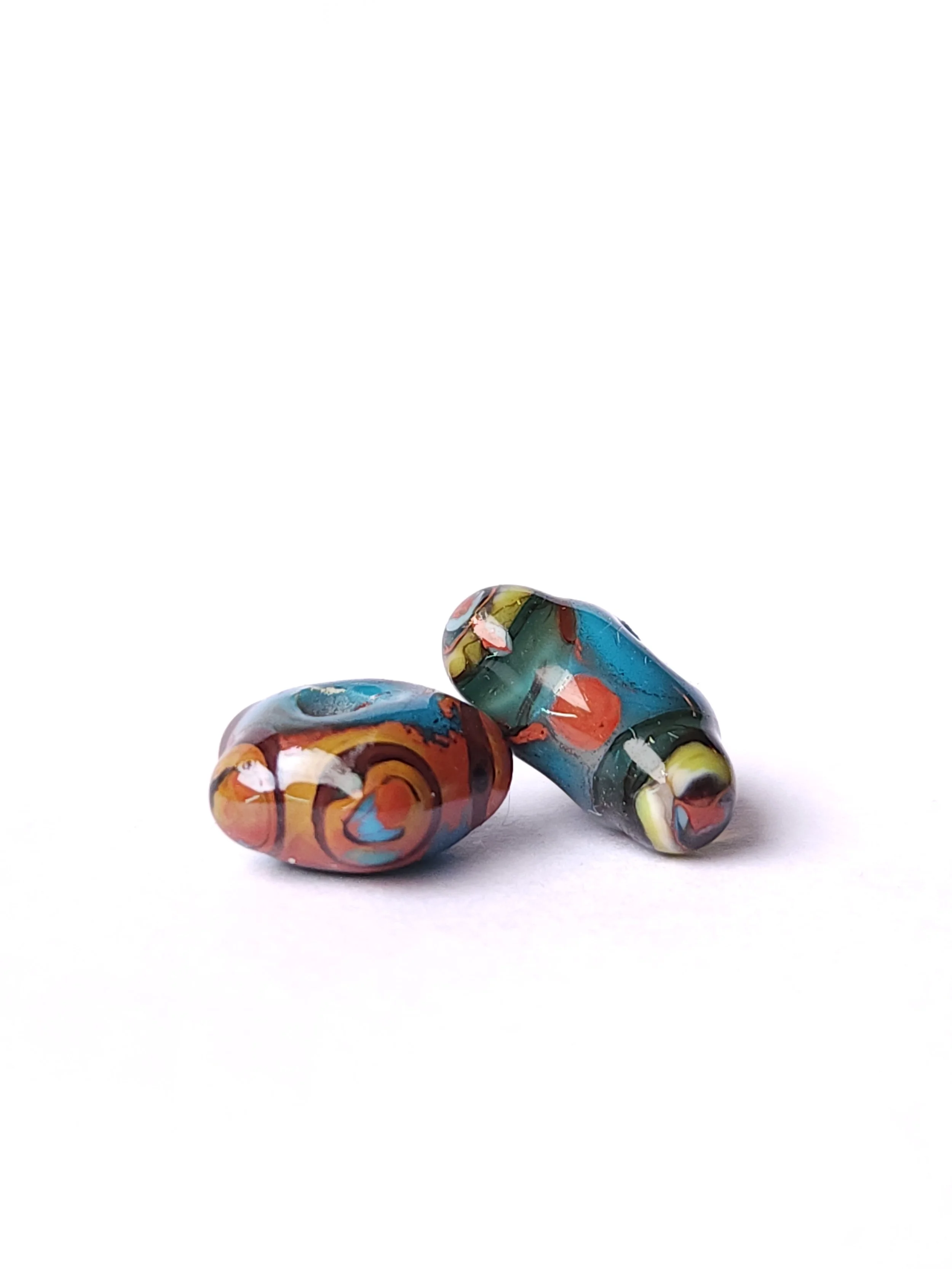 Selection of glass lampworked beads in natural earth tones. 