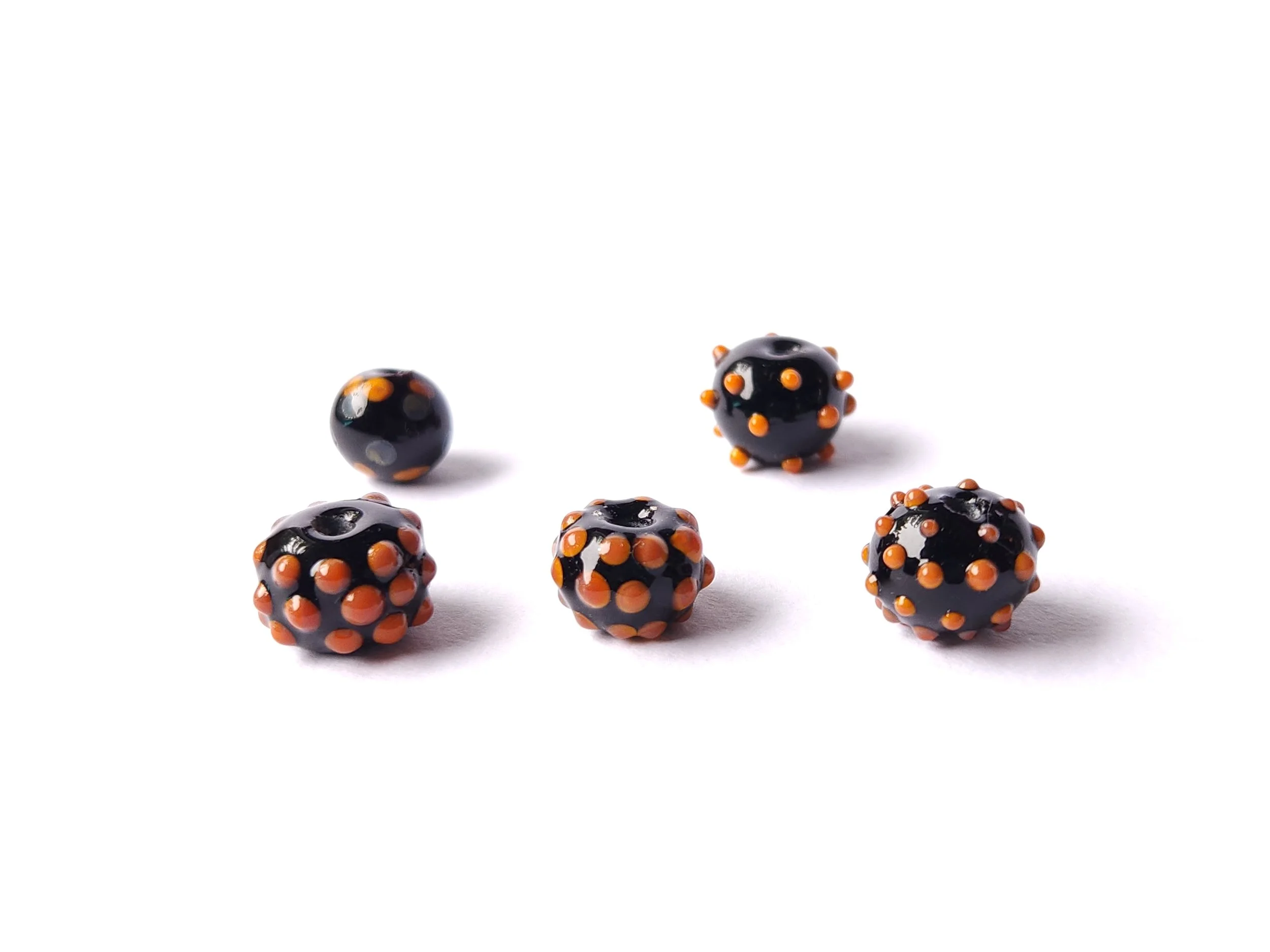 Lampworked glass beads for Halloween with orange and black. 