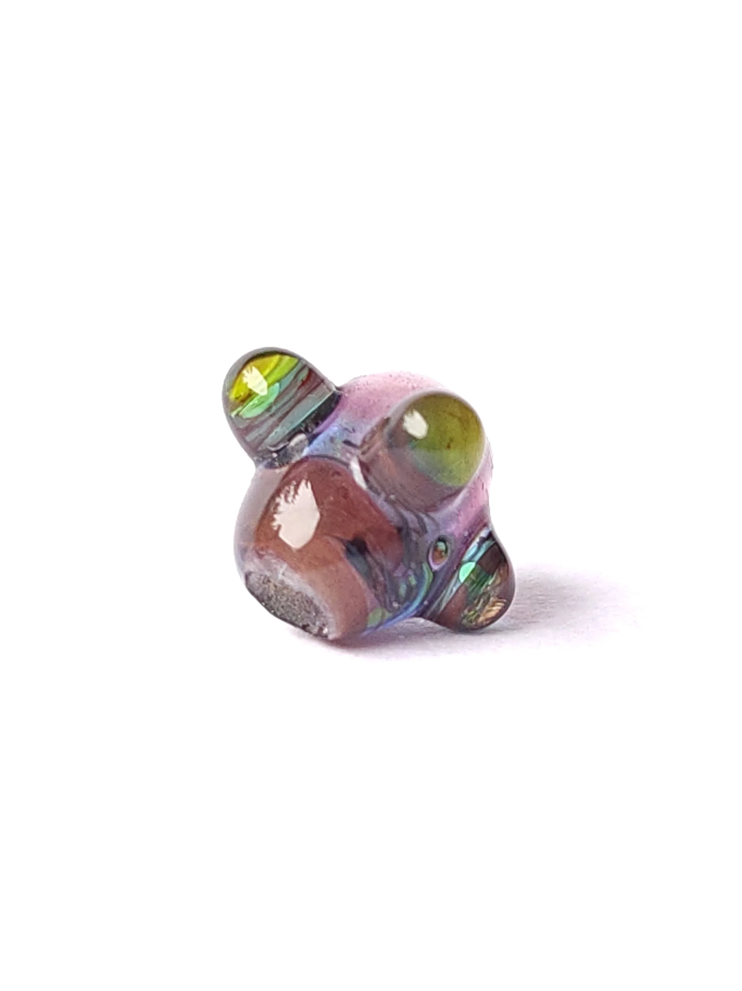 Transparent glass lampworked bead. Multicolor base with layered dots. Close up image of glass bead. 