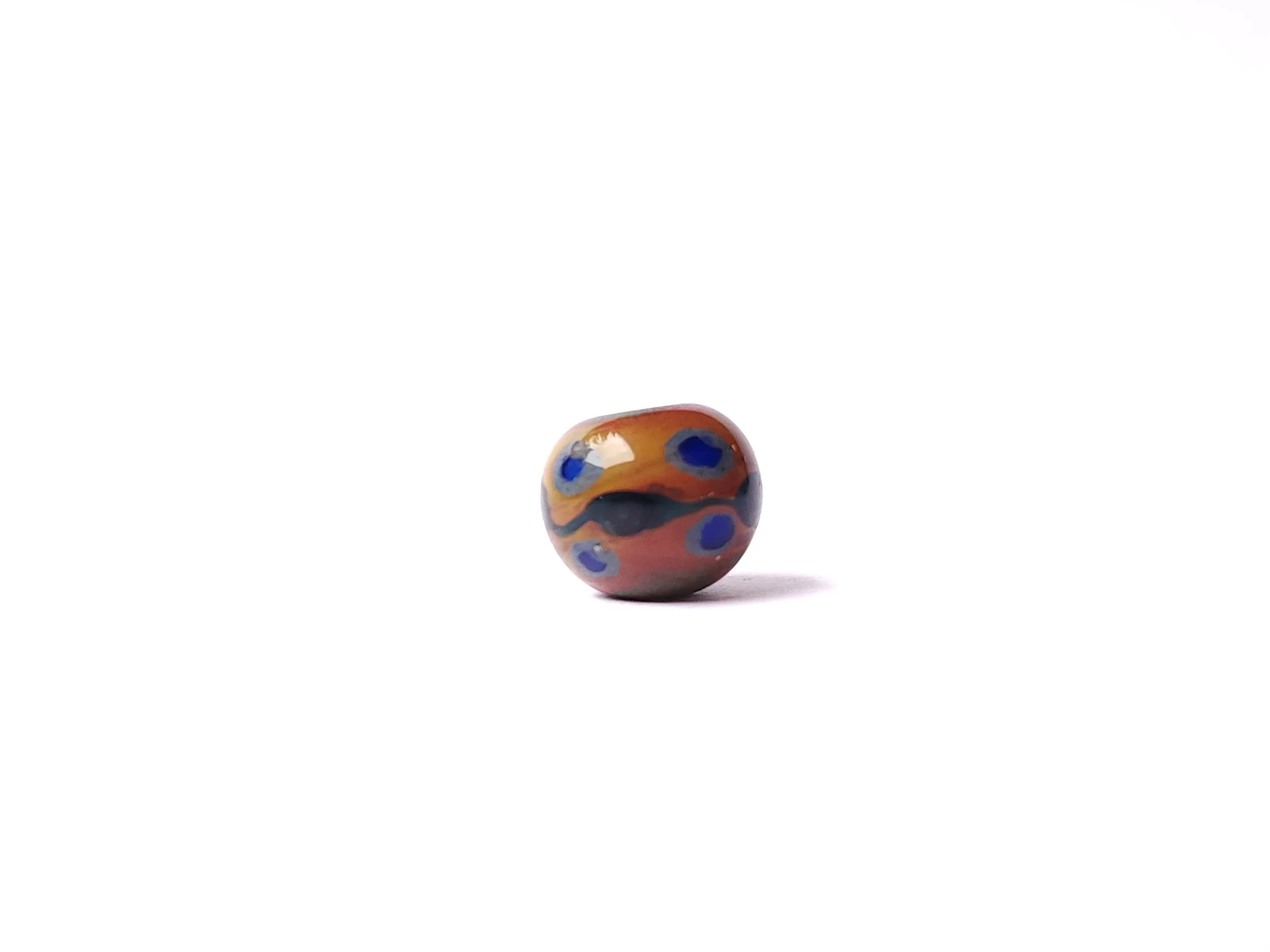 Glass lampworked dot bead in natural earth tones. 