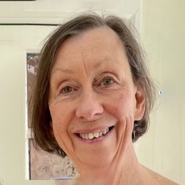 Black-and-white photo of a smiling woman with short dark hair