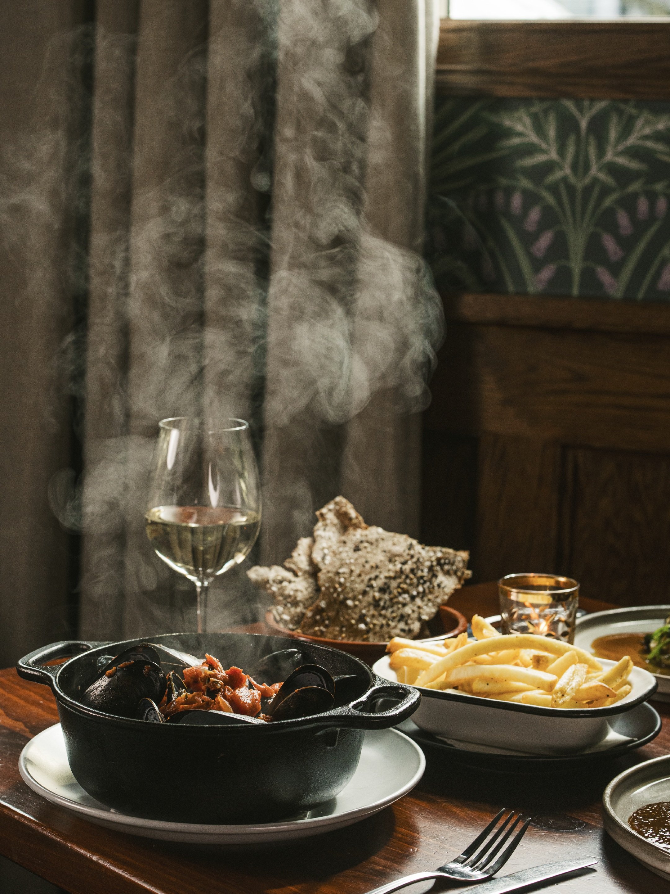 A little chill in the air, a little steam on the table. 

Warm up with our mussels frites, served in a white wine-tomato broth with Calabrian chili, fennel, and butter. Even better with a glass of white wine.

Your cozy weekend plans are waiting at P