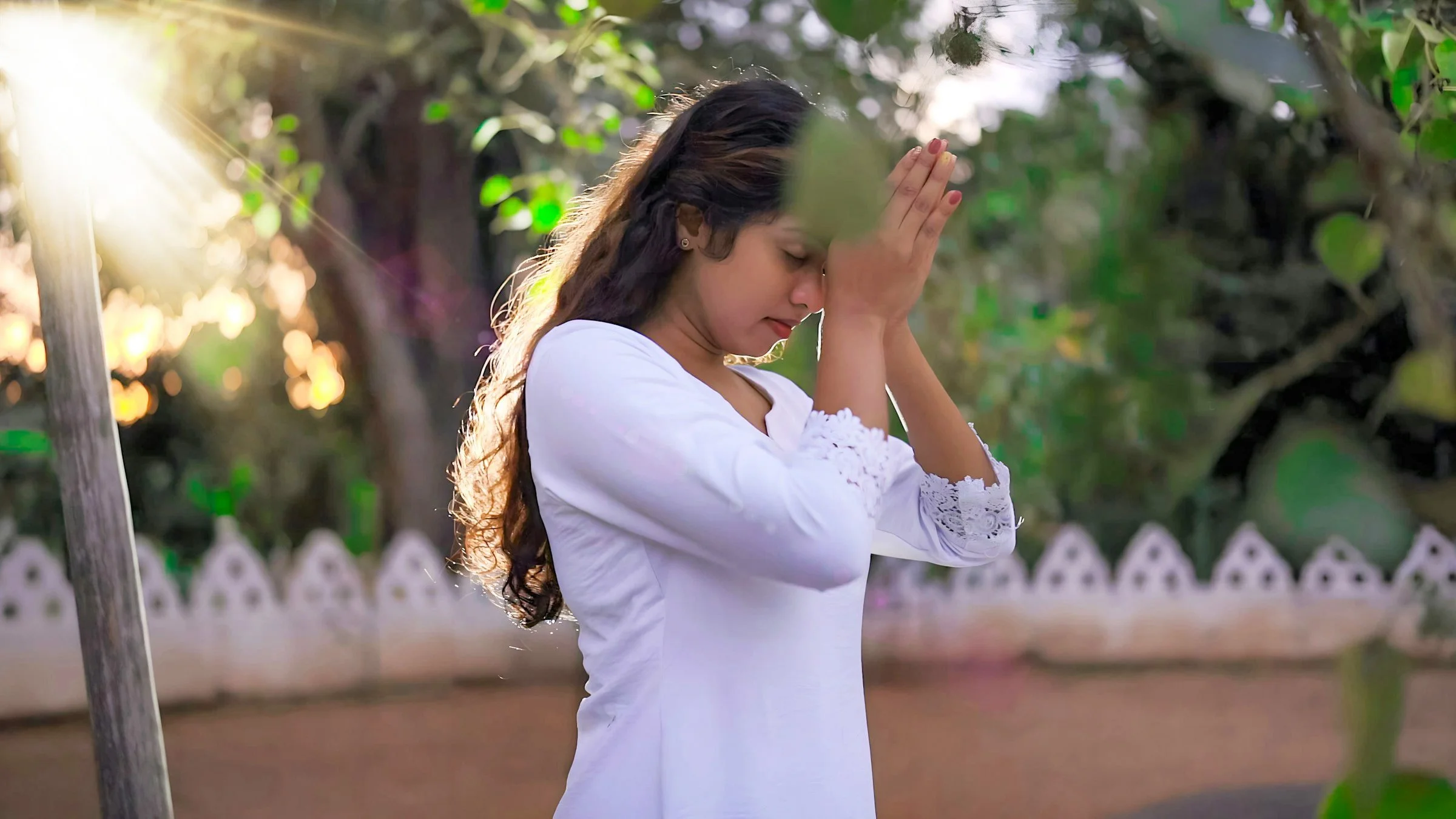 Woman worshiping in a Buddhist temple in Sri Lanka