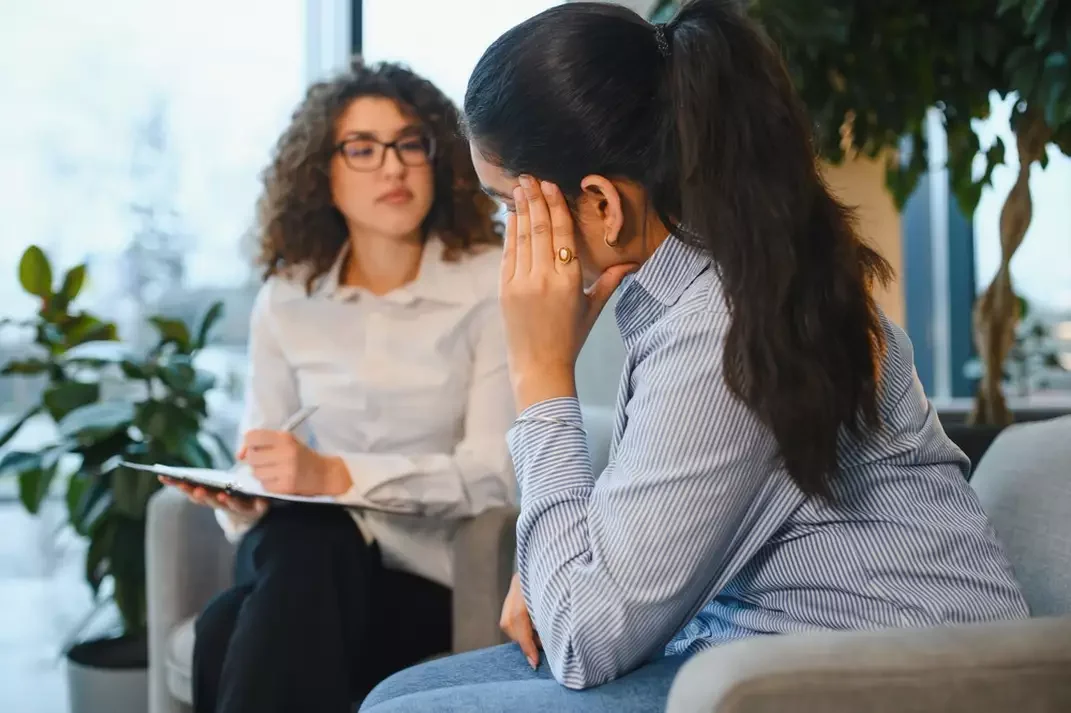 Woman talks with a therapist about anxiety, burnout, and feeling overwhelmed.
