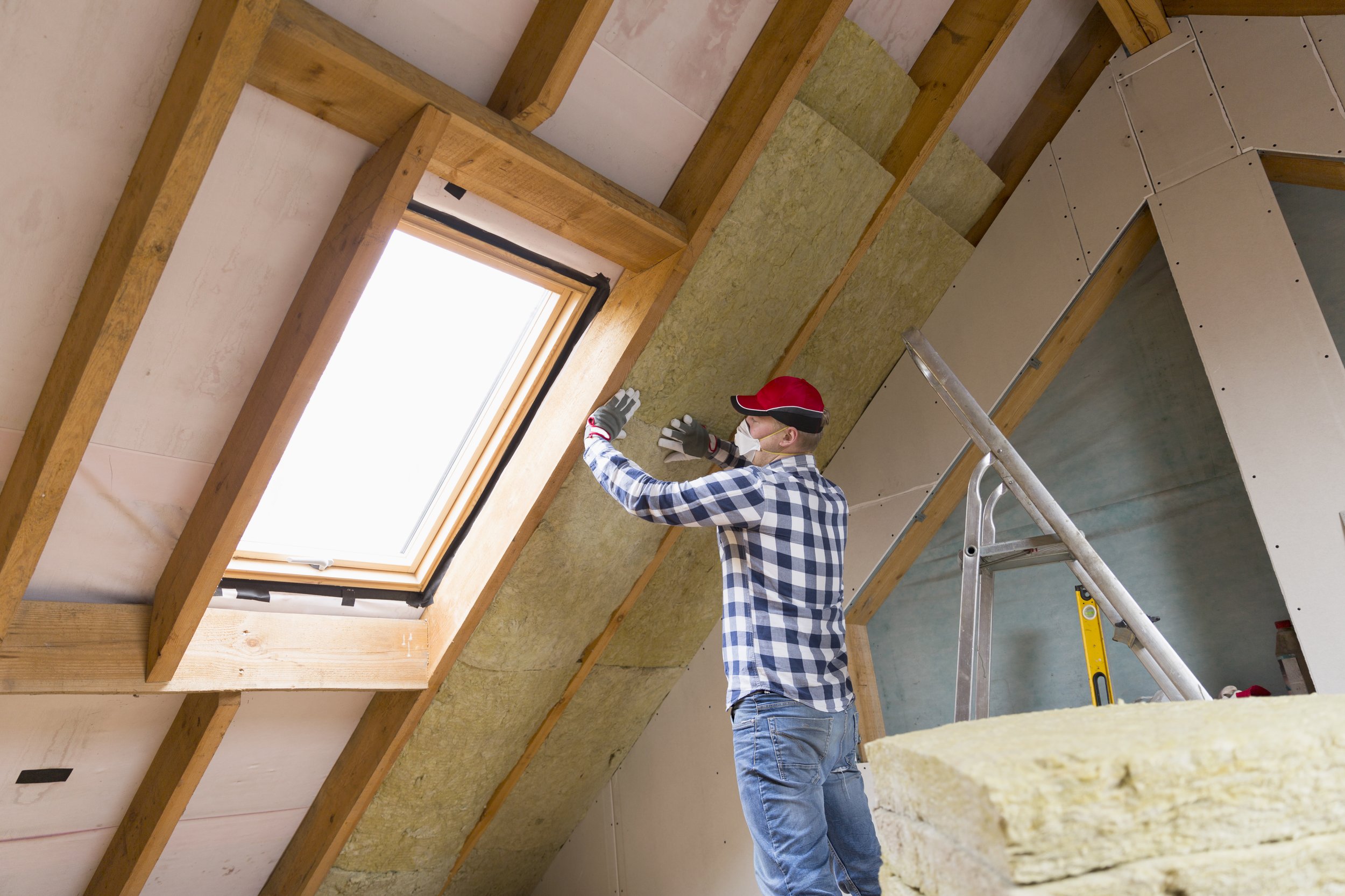 Man-installing-thermal-roof-insulation-layer---using-mineral-wool-panels.-Attic-renovation-and-insulation-concept-873936670_5760x3840.jpeg