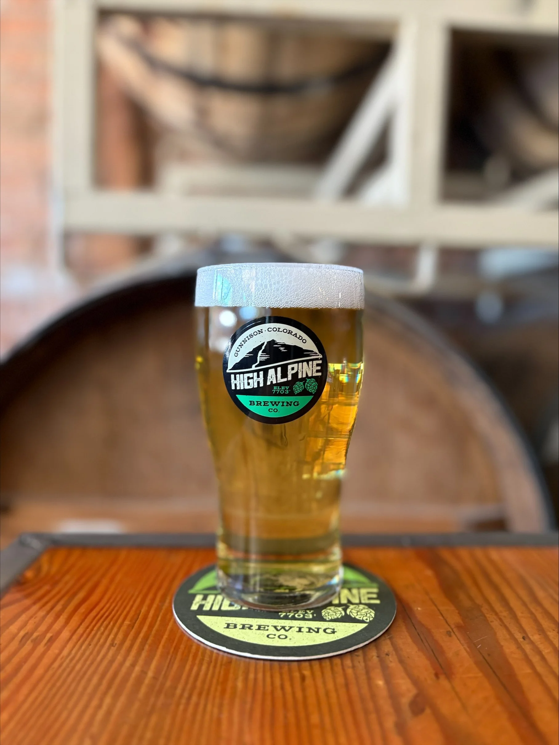 Pint glass of German Pilsner on wooden table