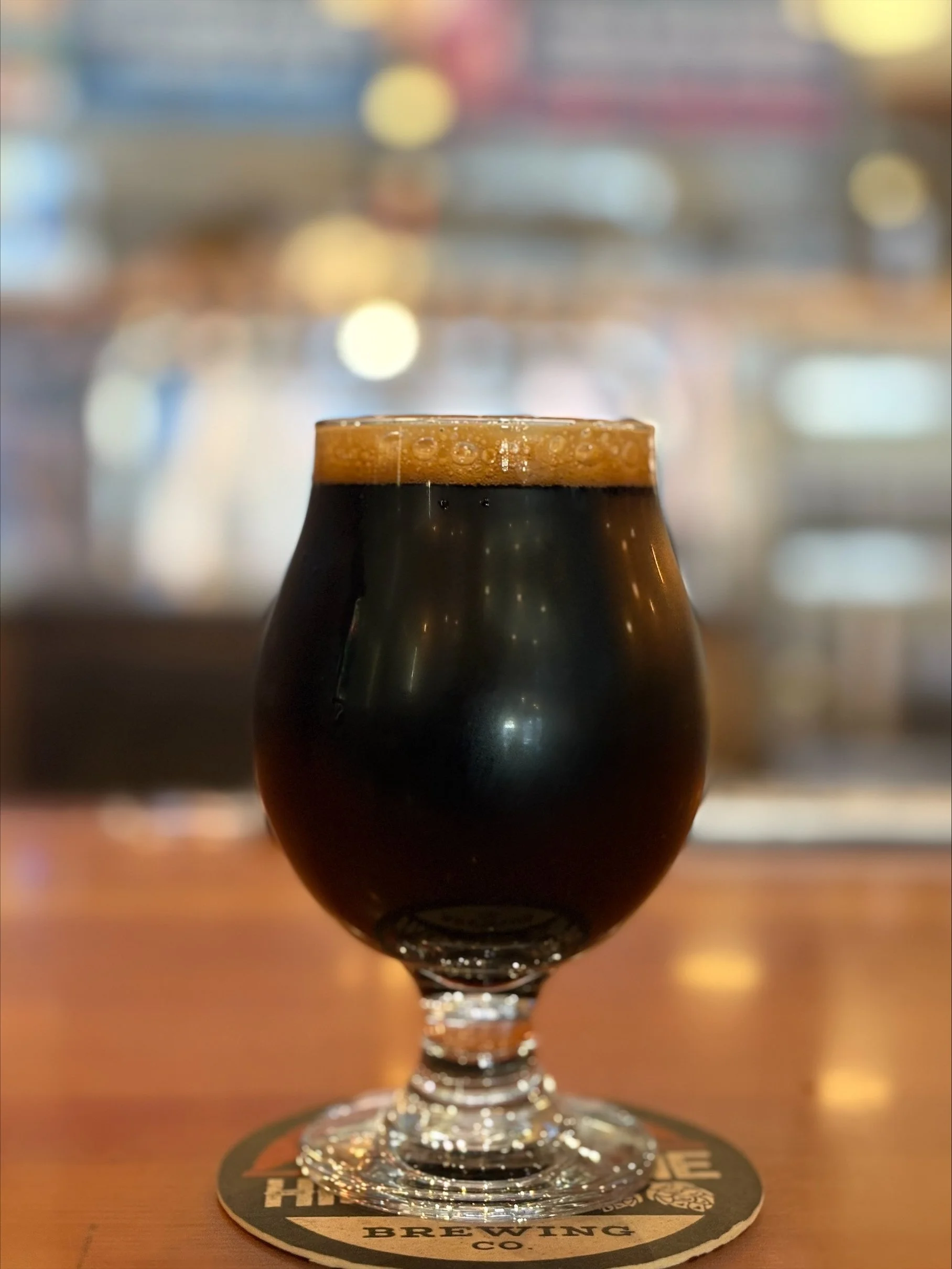 Pitch brown/black beer in tulip glass