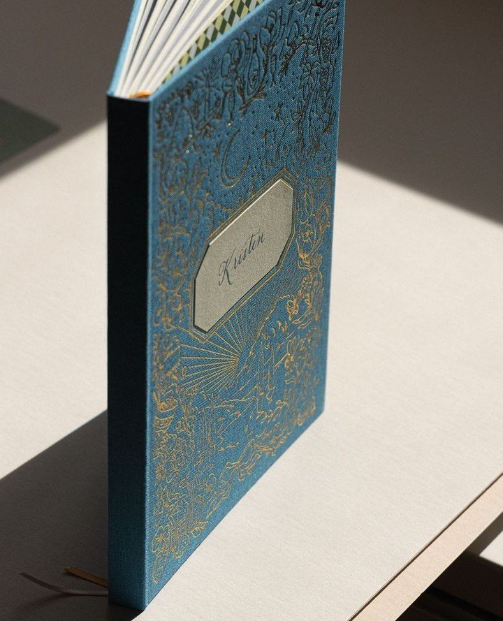 This is a book we created, start to finish. All the illustrations on the cover, the hand-calligraphed bookplate, the whimsical bookends, foil stamped cover on a French blue cloth cover, all bound as a hardcover book. We spent hours choosing just the 