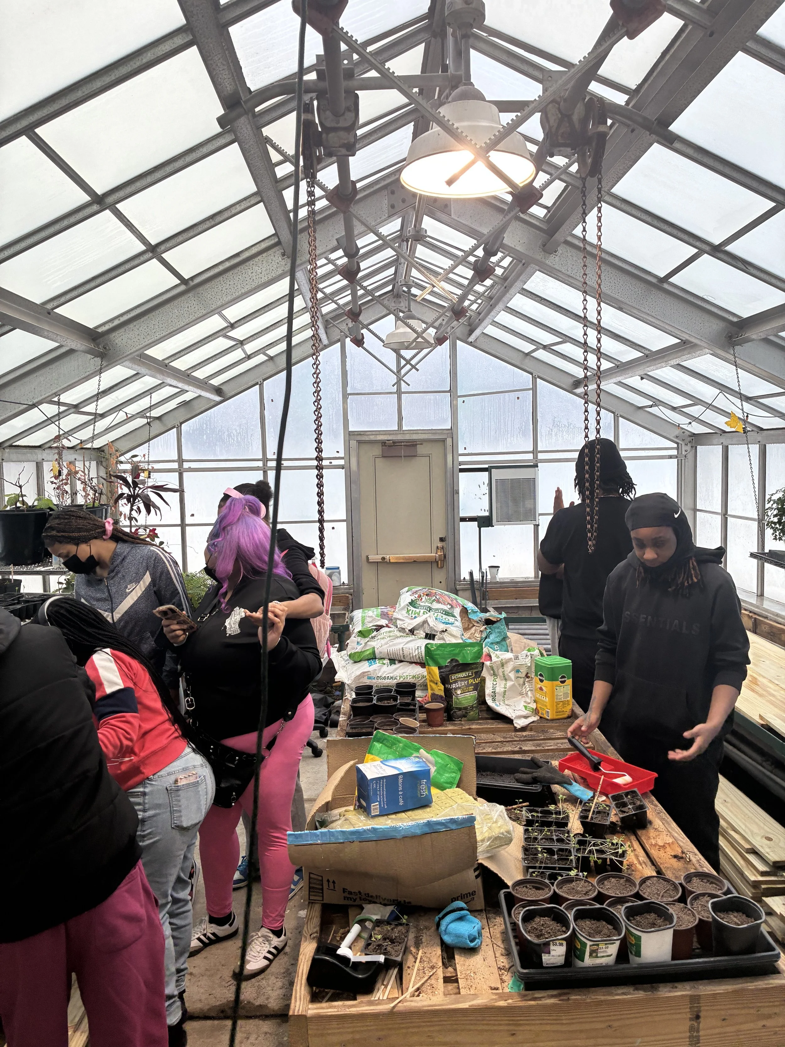 JWBYI's Workforce Development team working inside the greenhouse