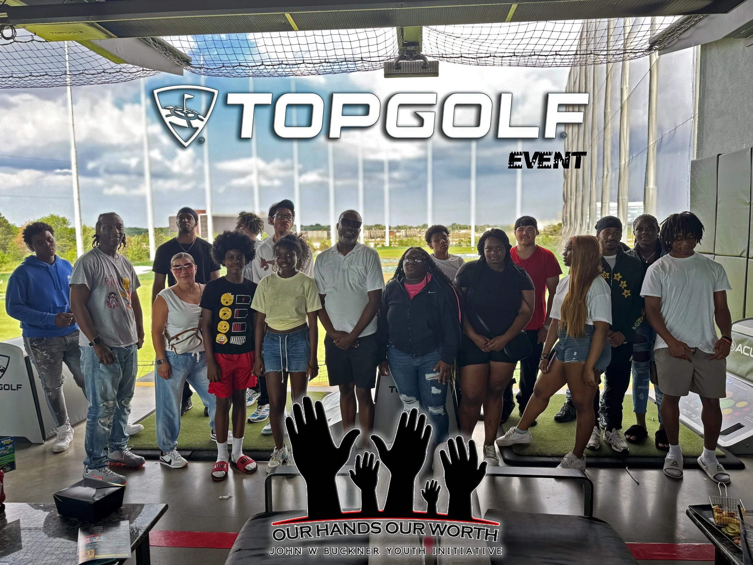 Group of diverse people at a Topgolf event inside a practice bay, with large windows showing a golf range outside. The image has a black graphic of raised hands and the text 'Our Hands Our Worth' with additional branding for the John W Buckner Youth 