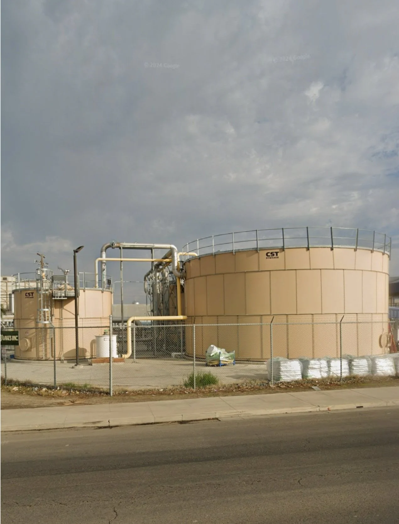 Chemical storage tanks connected to SCADA-controlled wastewater pH stabilization system