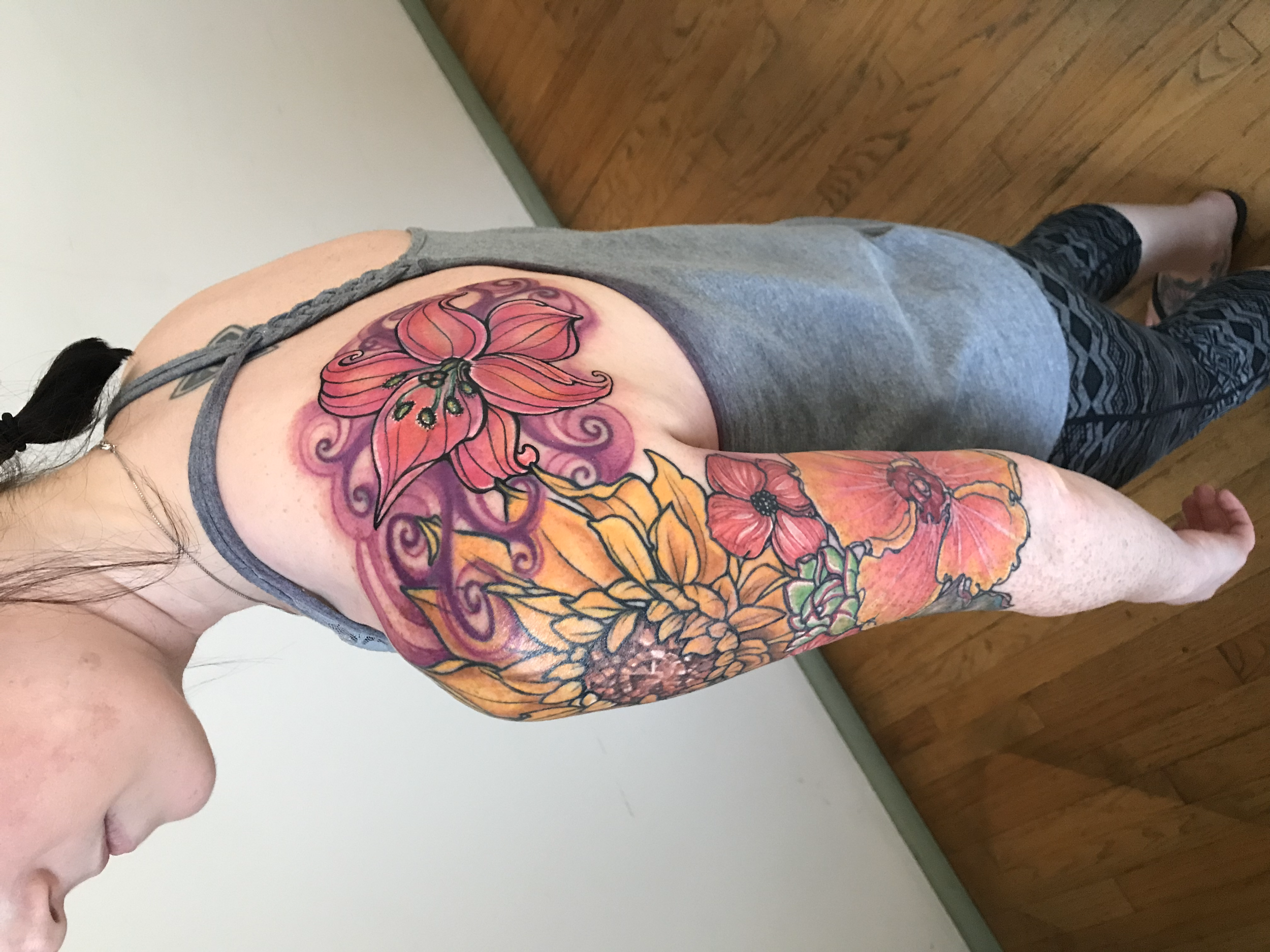 Kat had an existing tattoo on her shoulder of a lily. She wanted to add a half sleeve with specific flowers and connect them to her shoulder piece. She also wanted the lily to be updated and refreshed. We reworked the shoulder tattoo at the very end 