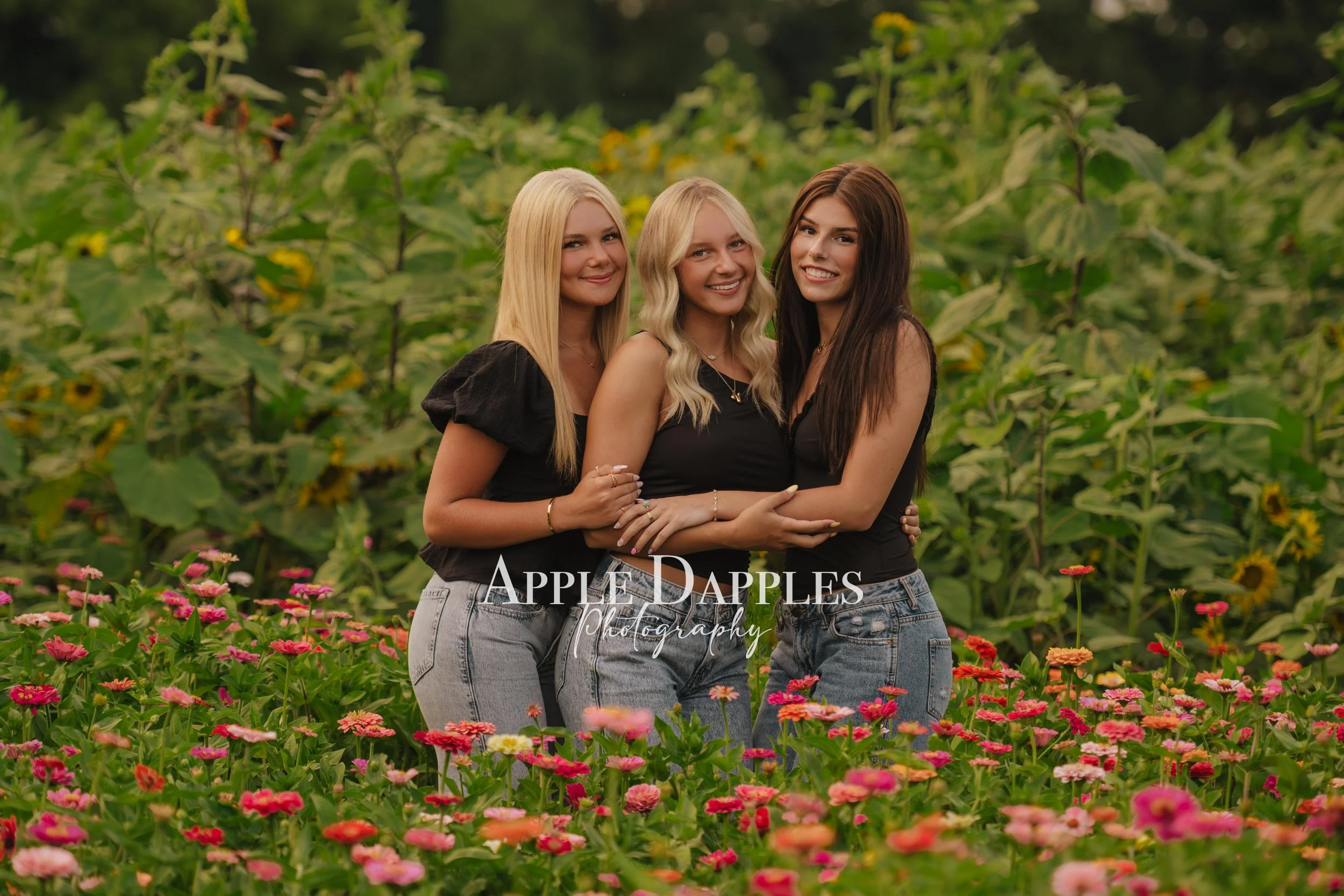 High school senior portrait in a sunflower and zinnia flower field