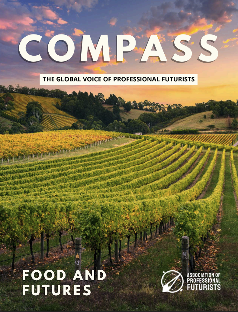 Vineyard fields at sunset with the word 'COMPASS' and the phrase 'The Global Voice of Professional Futurists' overlaid. The bottom text reads 'Food and Futures' and the logo of the Association of Professional Futurists is in the bottom right corner.