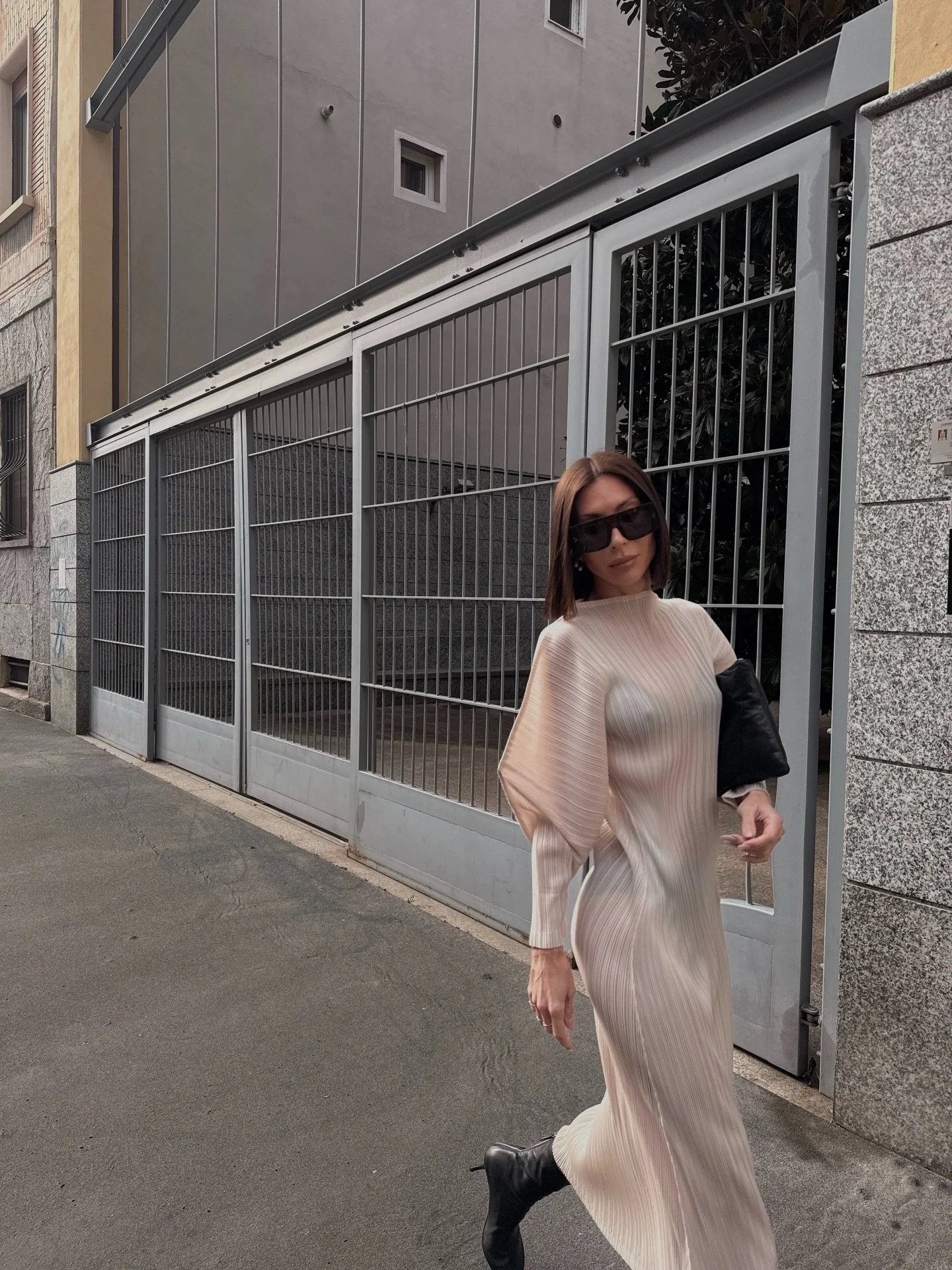 I always come back to this contrast &mdash; elegant and soft, styled with something a bit more edgy.
A lightweight elegant pleated dress with a sculptural cut, soft and minimal but with attitude, layering it with a leather bomber adds that effortless