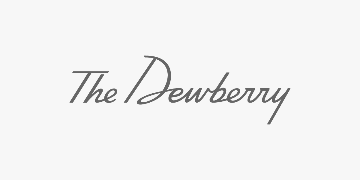 Text reading 'The Dewberry' in elegant, cursive font on a light background.