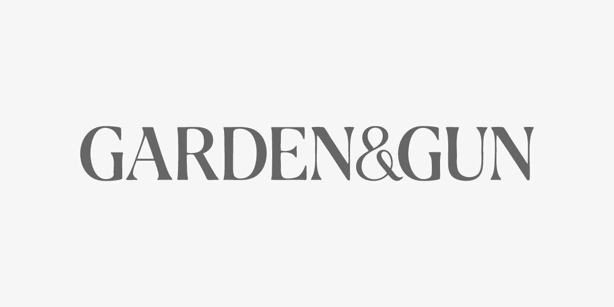 Text reading GARDEN & GUN in gray font on a light background.