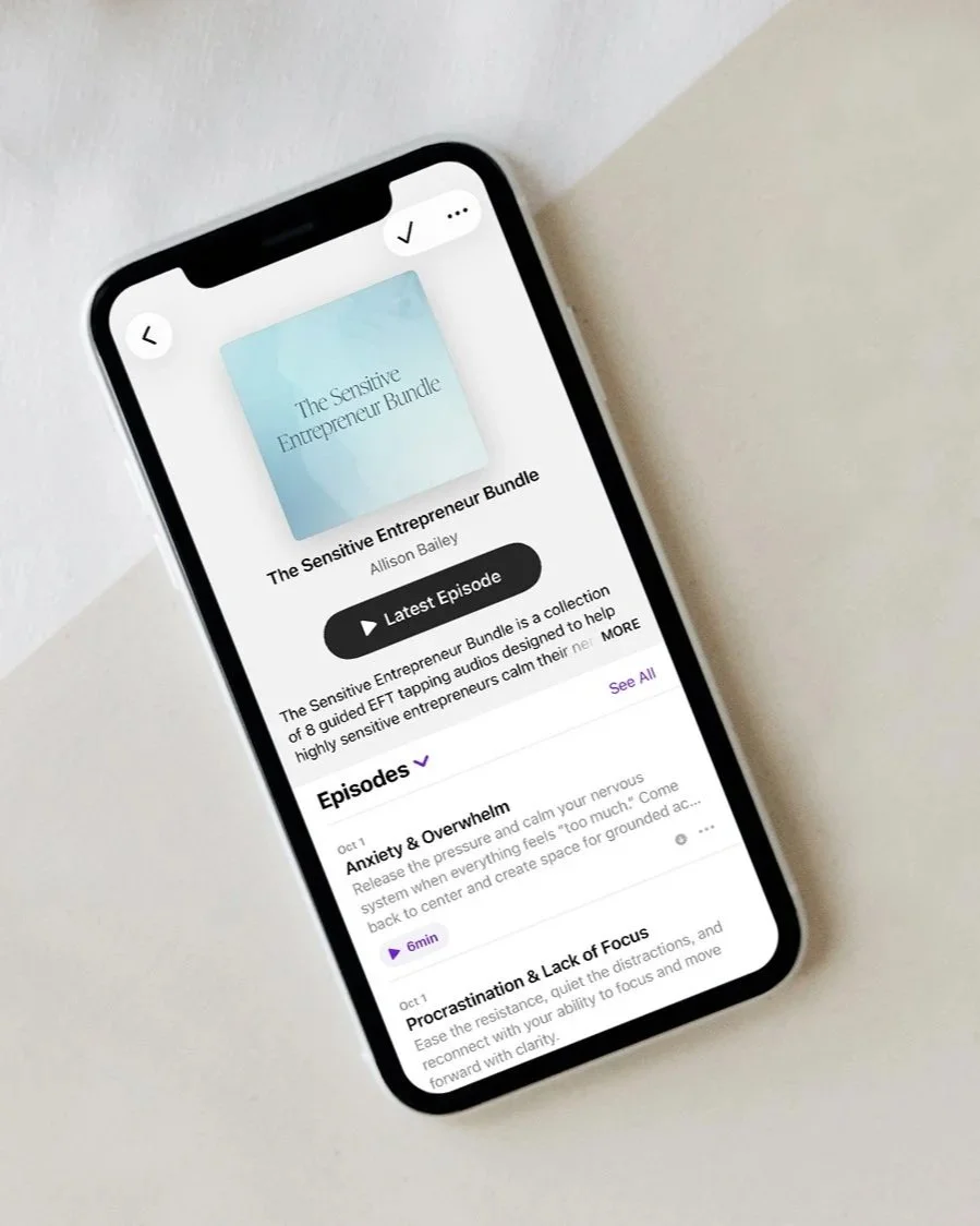 Smartphone displaying a podcast episode titled 'The Sensitive Entrepreneur Bundle' by Allison Bailey, with episodes on anxiety, overwhelm, procrastination, and focus.