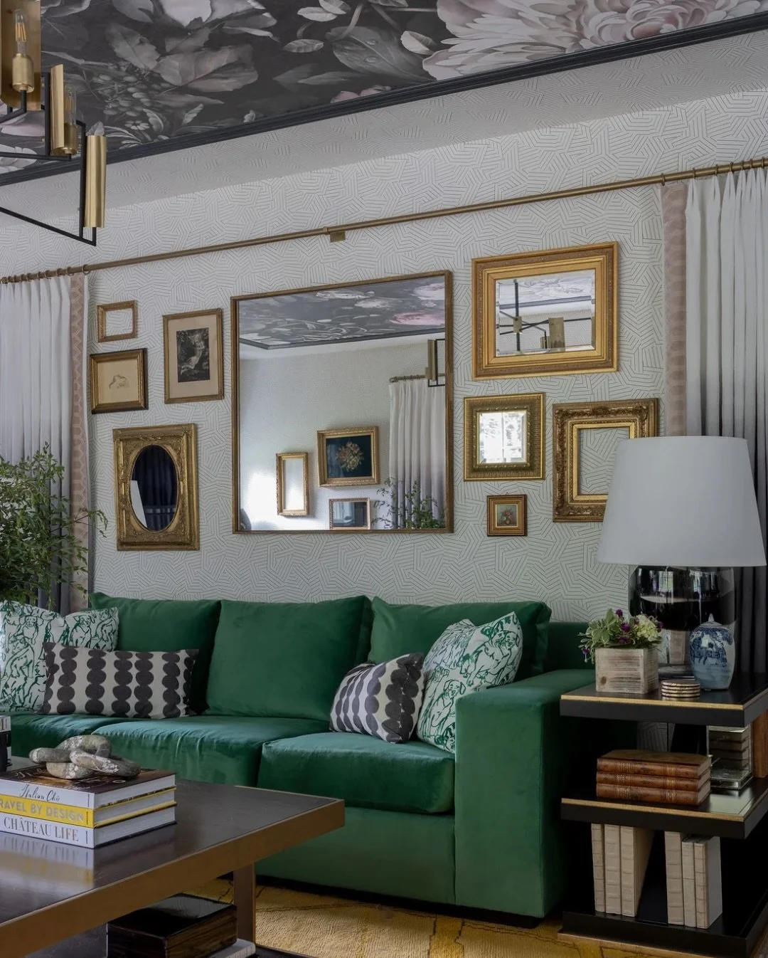 Wallpaper on the ceiling? Absolutely! In this long, narrow family room, a dramatic floral wallcovering reframes the architecture and turns an often-overlooked surface into the room&rsquo;s most compelling feature. The black molding creates a crisp bo