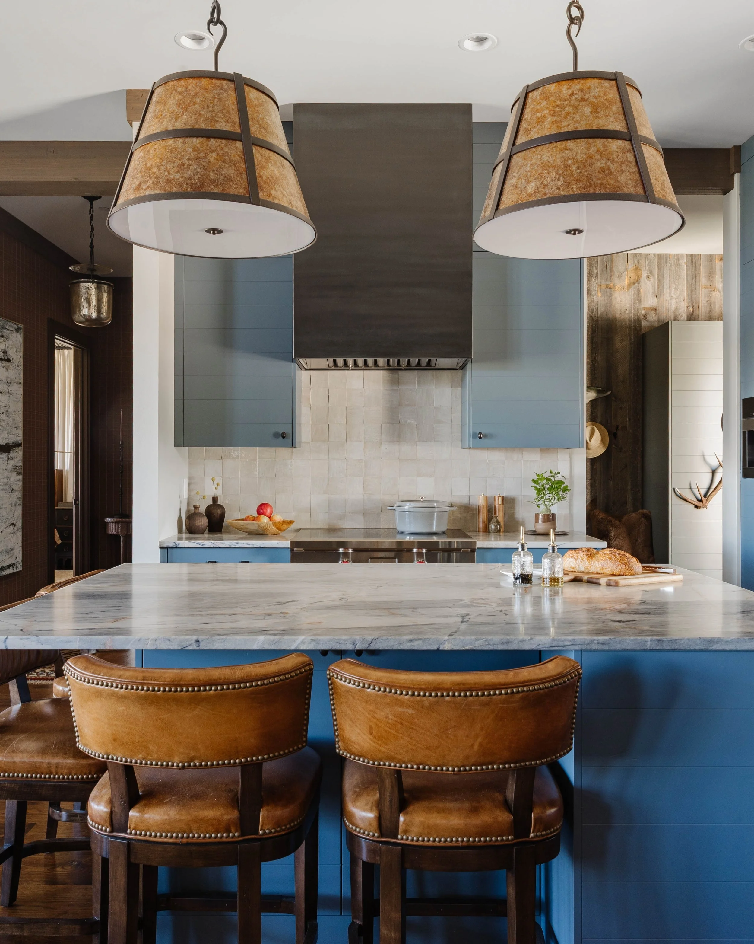 This kitchen became one of the clearest expressions of the transformation inside this Utah cabin. What once felt a little too quiet for its mountain setting now has richness, contrast, and a softer glow, from the blue cabinetry to the opalescent ligh