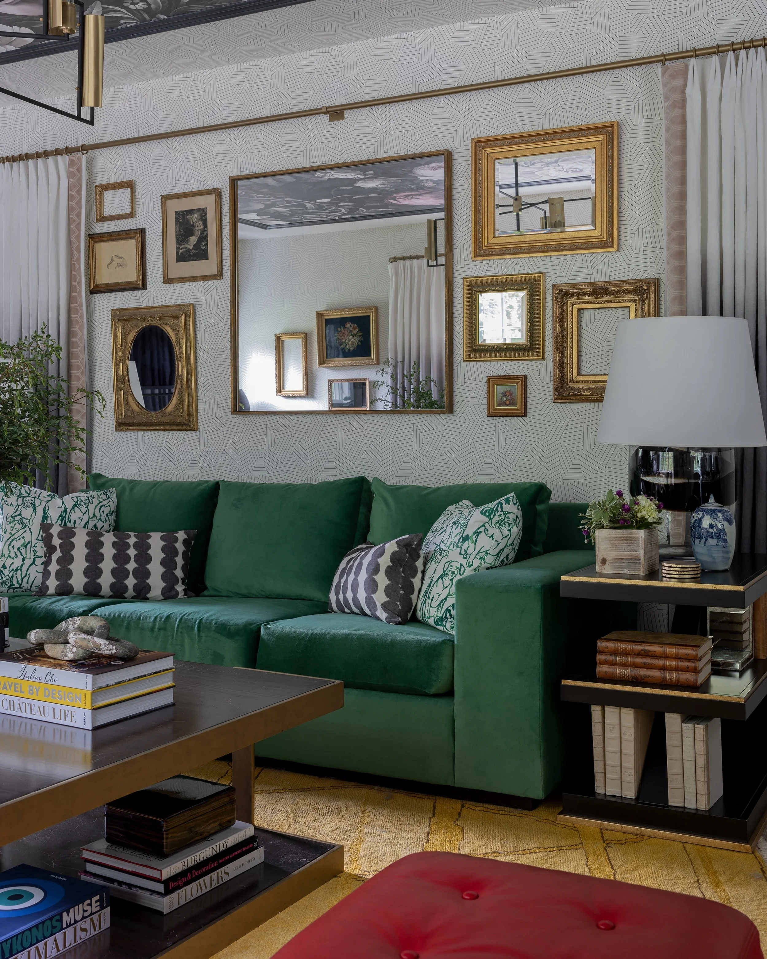 Not every frame has to play the same role. In this family room, some hold art, some reflect the room back through mirrors, and some are left open to become part of the composition themselves. The result is a wall with movement, personality, and a lit