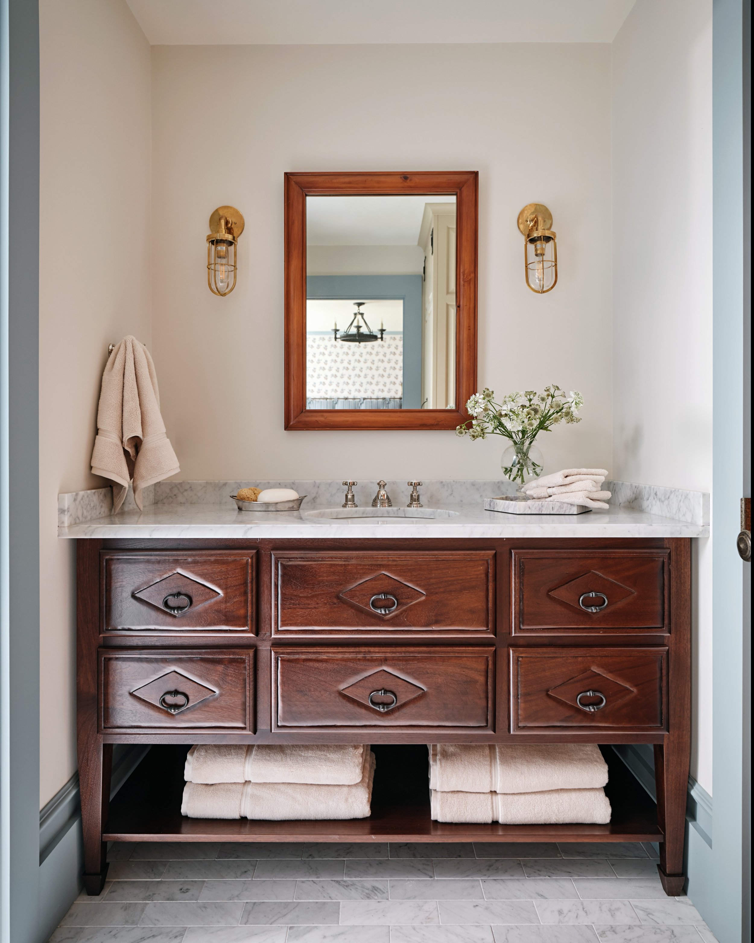 We loved the idea that the bathroom vanities could feel found rather than installed. Each one was custom designed to look like an old piece of furniture repurposed for the bath, adding another layer to the home&rsquo;s made-over-time feeling.

Interi
