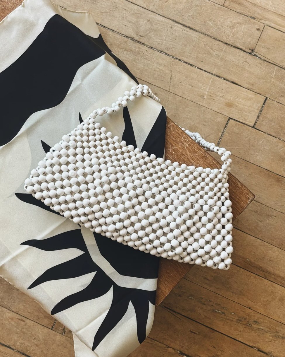 New @bembien beaded shoulder bag, handcrafted from 100% natural wood beads, designed for day-to-night wear. It features a single beaded strap and magnetic closure, and fits an iPhone and card case