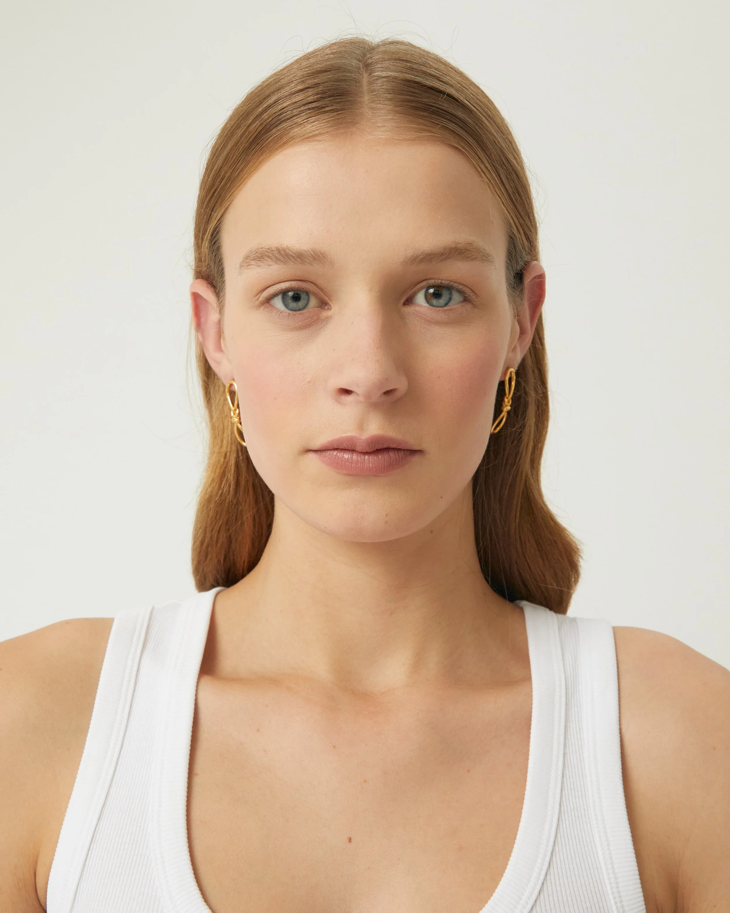 KNOTTED EARRINGS - GOLD - ON BODY - FRONT.jpg