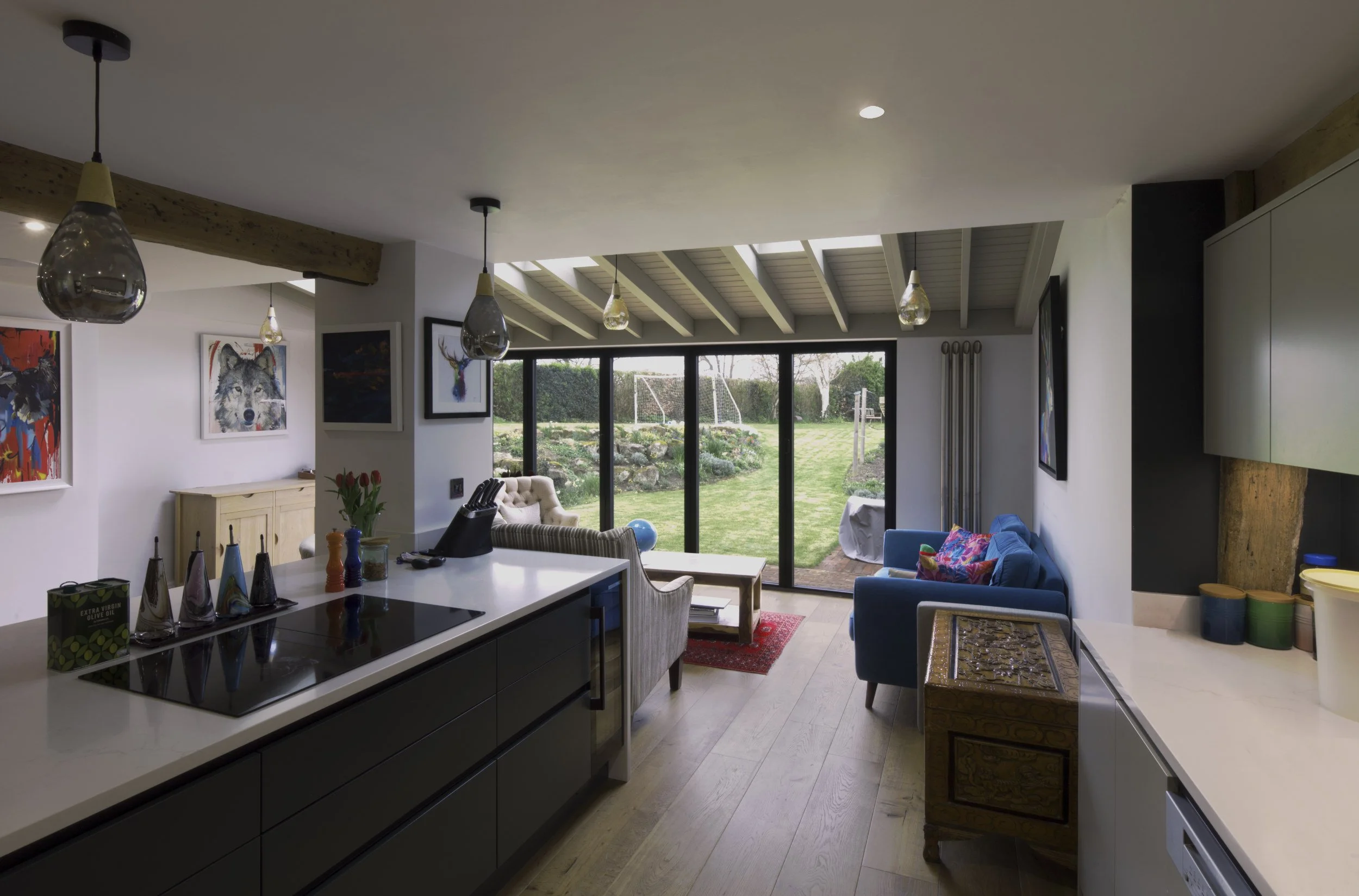 View of the opened up floor plan showing the kitchen and the garden beyond.